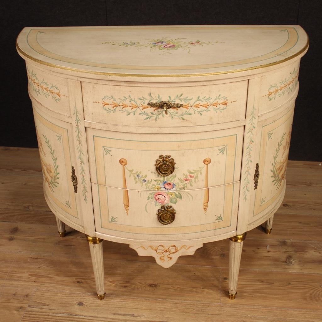 French demilune dresser from the second half of the 20th century. Lacquered, gilded and painted wood commode with very pleasant landscapes and floral decorations. Furniture with three central drawers and two side doors of good capacity and service.