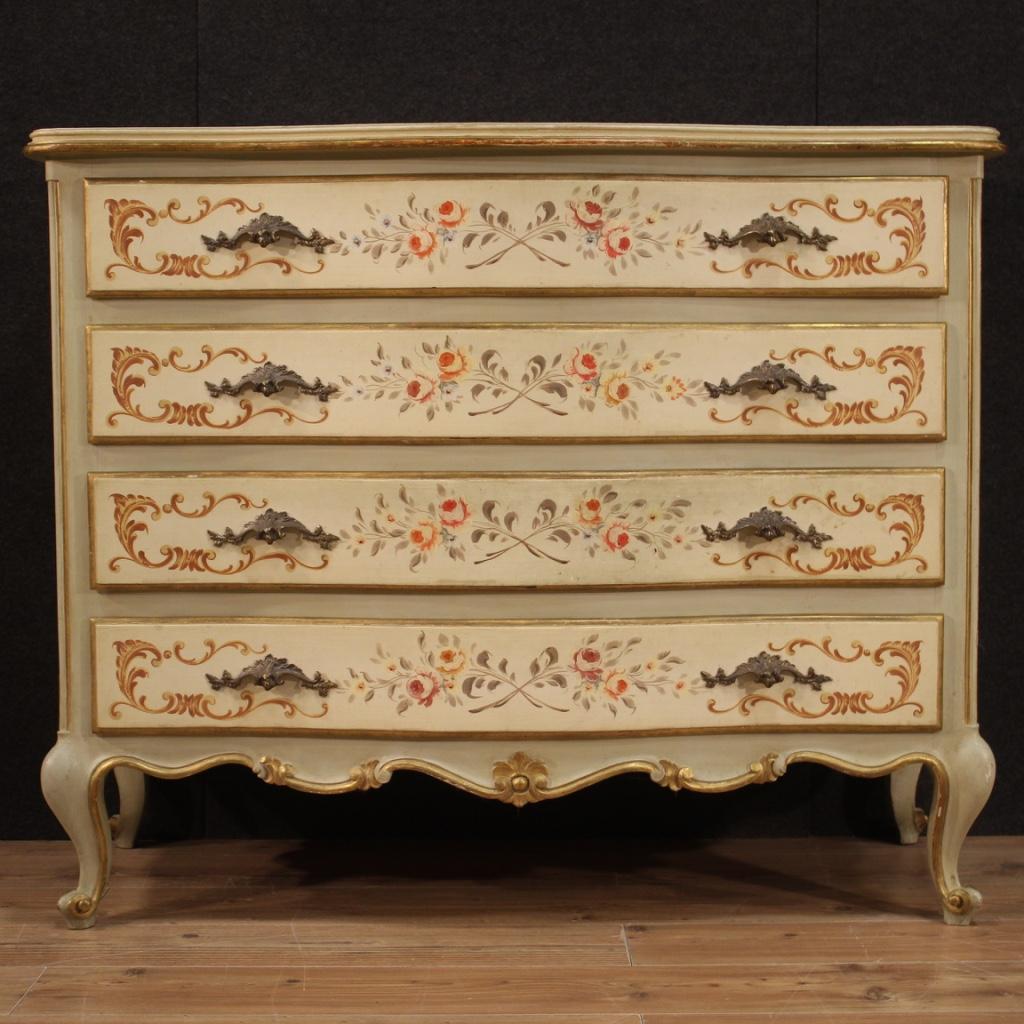 20th century Venetian commode. Moved and rounded furniture richly lacquered, gilded and hand painted of very pleasant floral decorations. Chest of drawers equipped with 4 front drawers of good capacity and wooden top in character also lacquered and