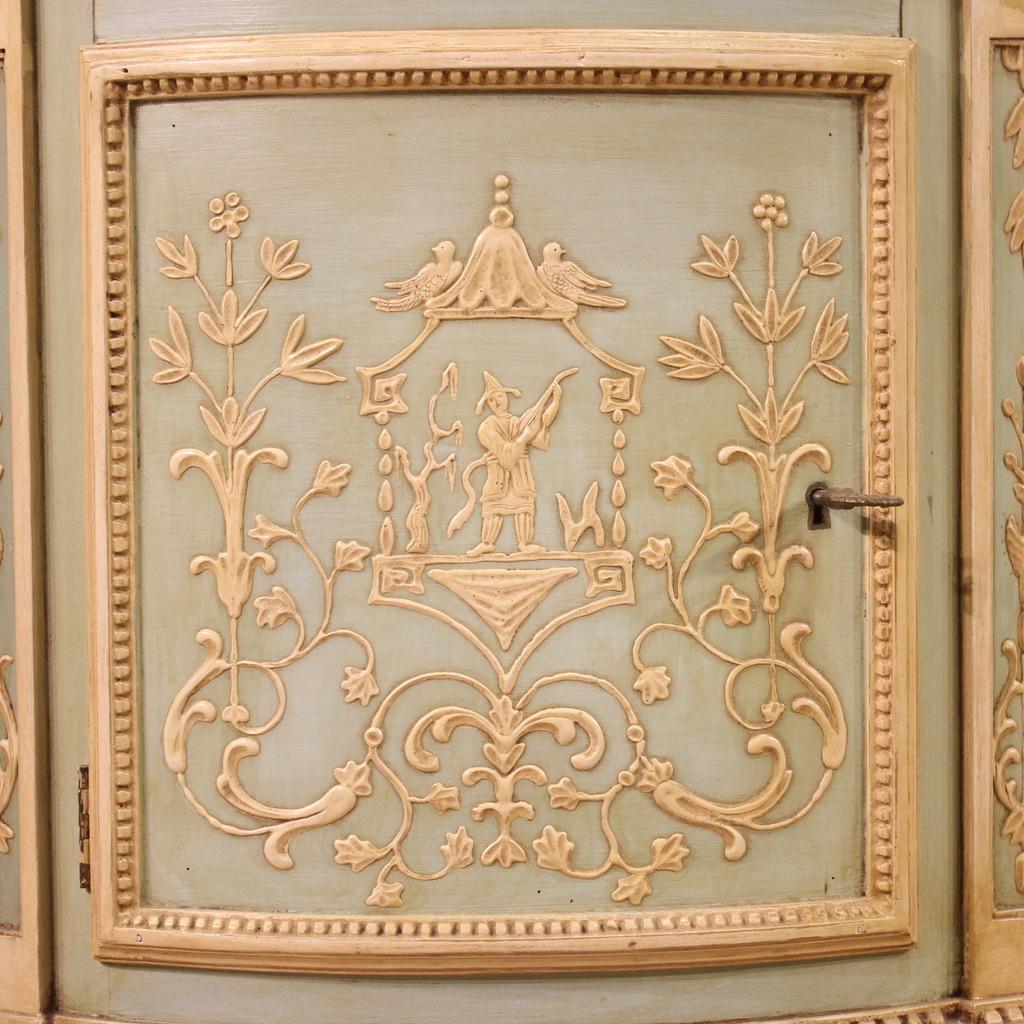 Half-moon commode in the Louis XVI style, Italy, mid-20th century. Furniture of exceptional quality in finely lacquered, chiseled and painted wood and plaster. Chest of drawers with three drawers and two side doors of excellent capacity. Half-moon