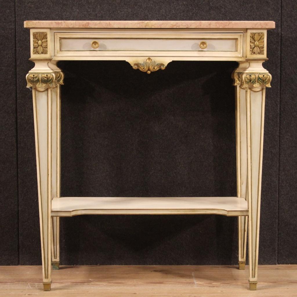 Italian console from 20th century. Furniture in carved, lacquered and gilded wood (bronze tint) in Louis XVI style. Console equipped with original marble top of good size and service, a front drawer and a second support shelf in the lower part (see