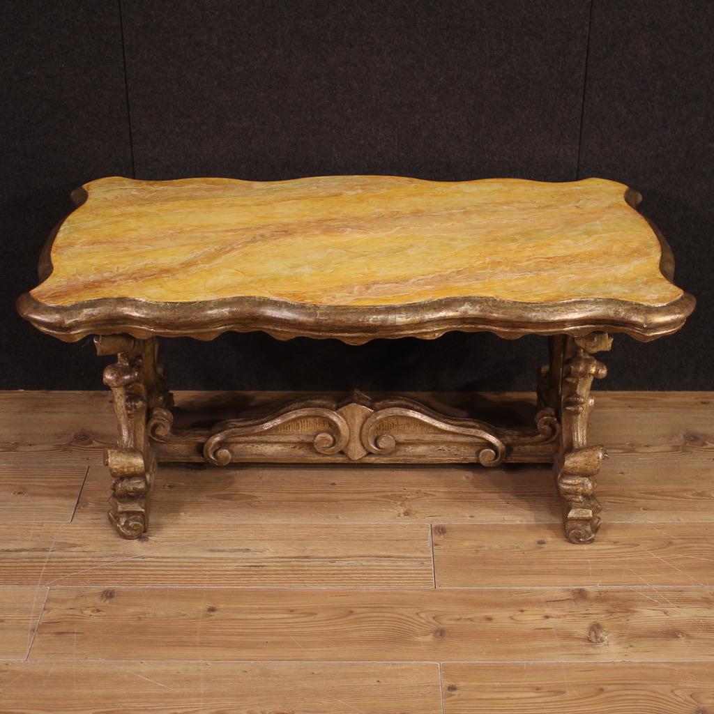 Venetian coffee table from the mid-20th century. Furniture of fabulous furnishings composed of pleasantly carved and lacquered antique wooden elements. Coffee table equipped with a countertop lacquered faux marble of excellent size and service.