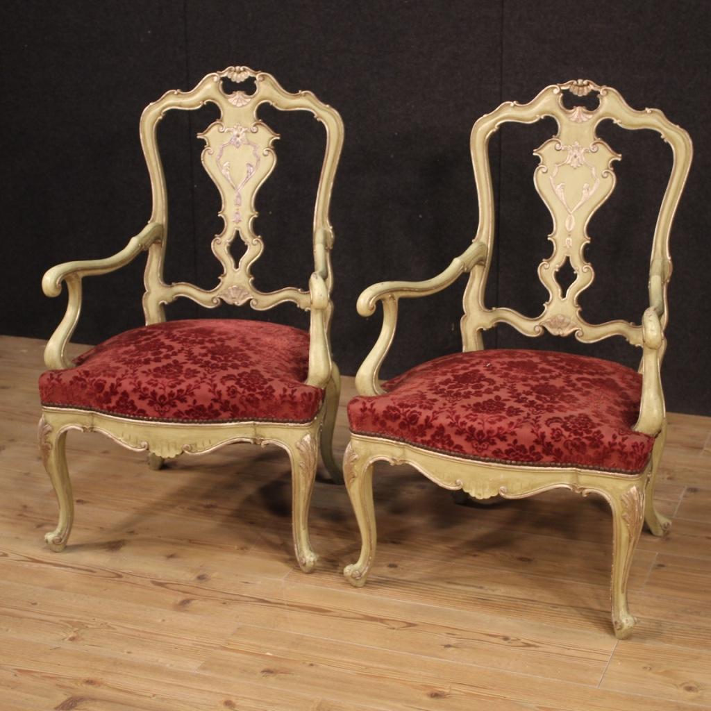 Pair of Venetian 20th century armchairs. Furniture in carved, lacquered and silvered wood of beautiful line and pleasant decor. Armchairs equipped with wooden armrests also lacquered and silvered. Seats in damask fabric and velvet with floral