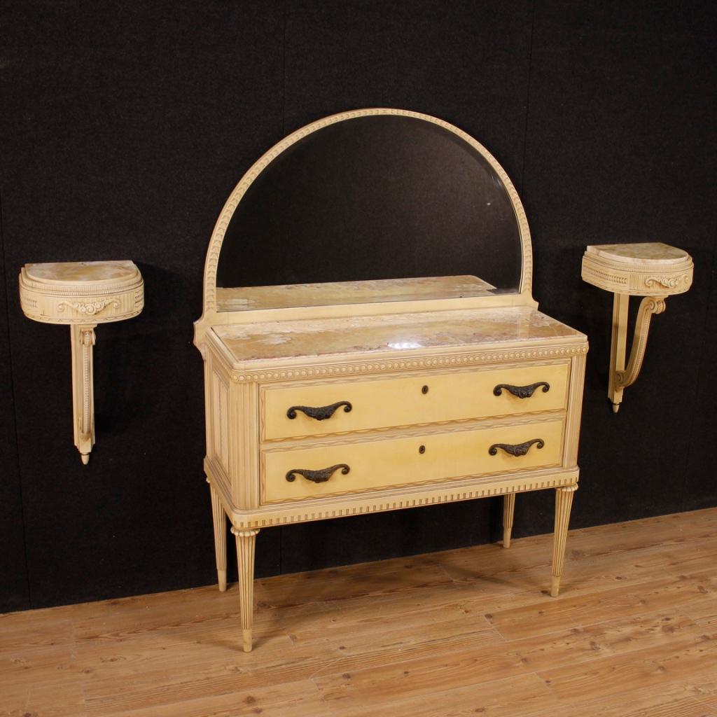 Pair of Italian bedside tables from the 1960s. Furniture in carved and lacquered wood of particular shape and construction. Wall-mounted nightstands fitted with a frontal drawer and marble top of reasonable capacity and service. Furniture that is