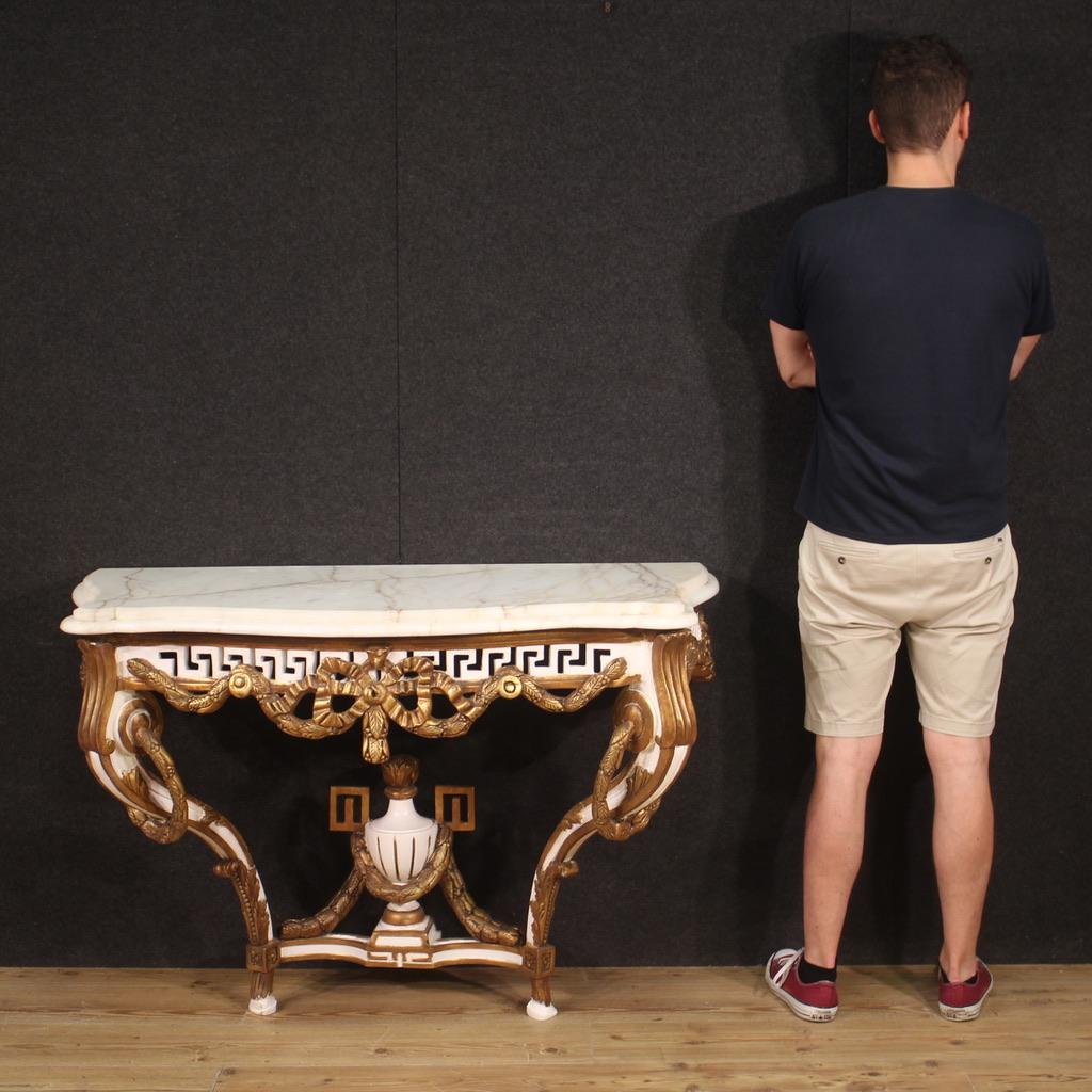 French console from the second half of the 20th century. Furniture in wood and plaster in the Louis XV style, carved, lacquered and gilded (bronze tint) of beautiful line and pleasant decor. Top in original marble, of considerable weight, great size