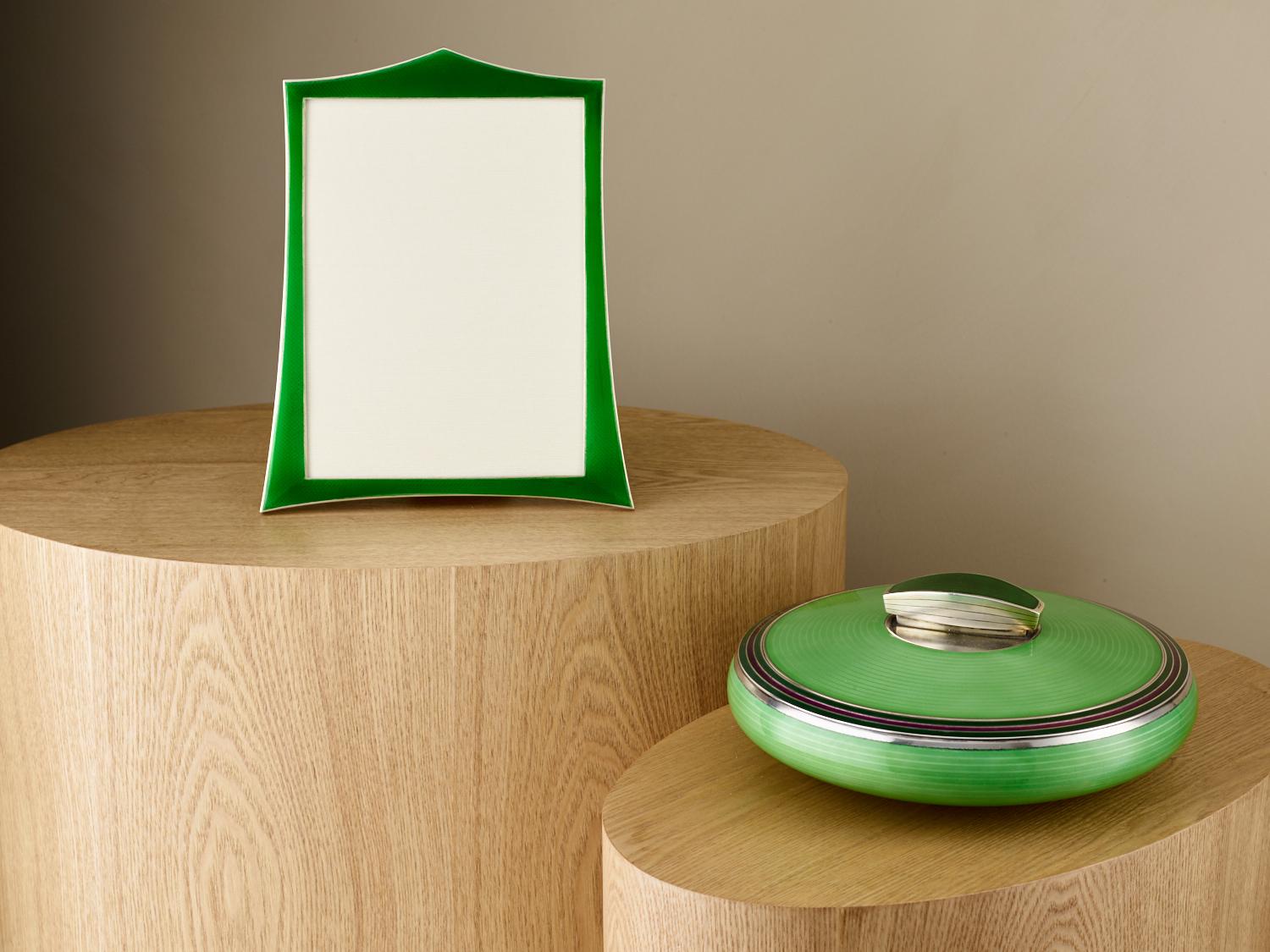 This stunning 20th century Art Deco sterling silver and guilloche enamel photo frame has that translucent quality.
The silver and beautiful green colored enamel are in excellent condition and the back and easel support are English oak.

This is a