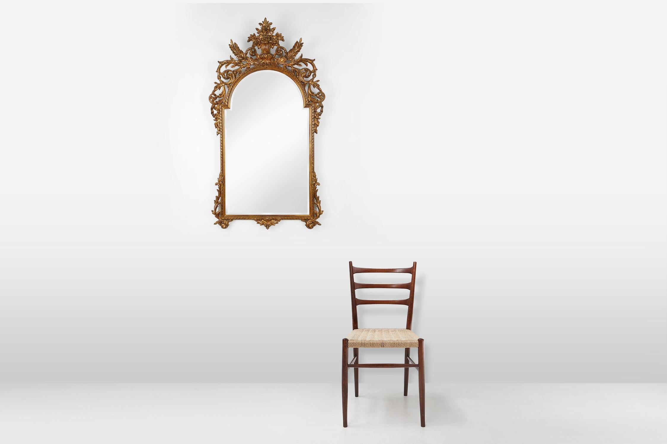 Belgium / 1950 / Mirror / Deknudt / wood, mirror / Baroque / Rococo 

Impressive gold framed rectangular mirror with rounded top with antique patina in Baroque style. The frame is richly decorated with floral decoration and acanthus leaves. With