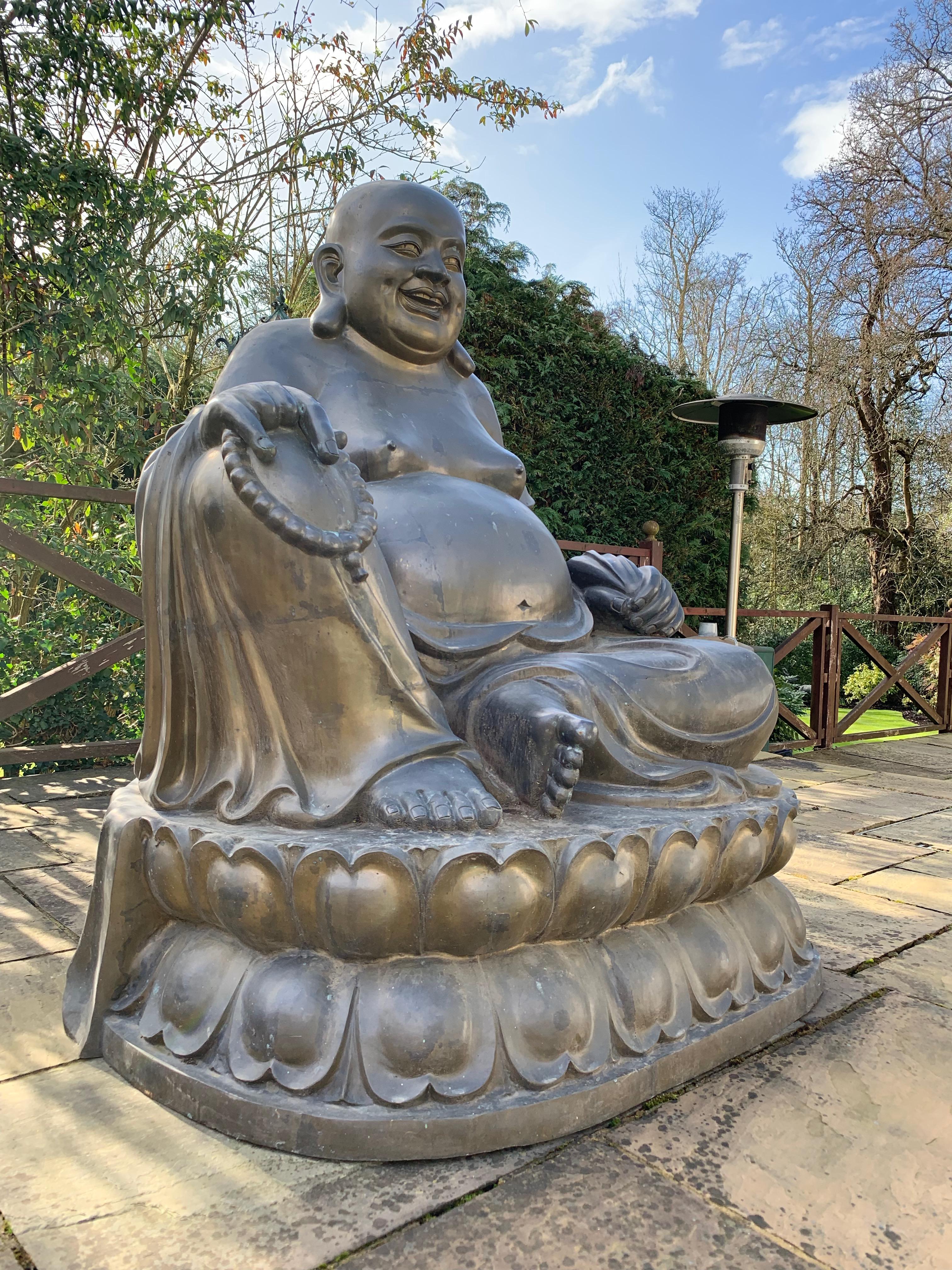 A large 20th century bronze laughing Budai originally from the New York apartment of John Legend, an American singer and songwriter.
Budai, Hotei or Pu-Tai is a semi-historical monk as well as deity who was introduced into the Japanese Buddhist