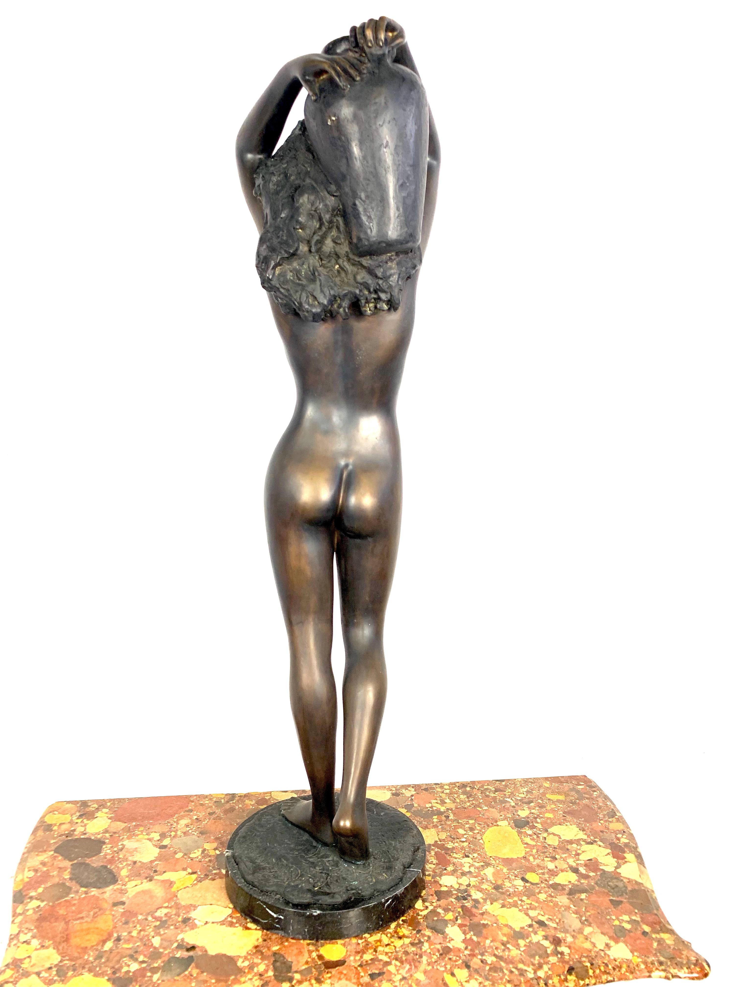 20th century large bronze sculpture of a nude young lady carrying a water urn.