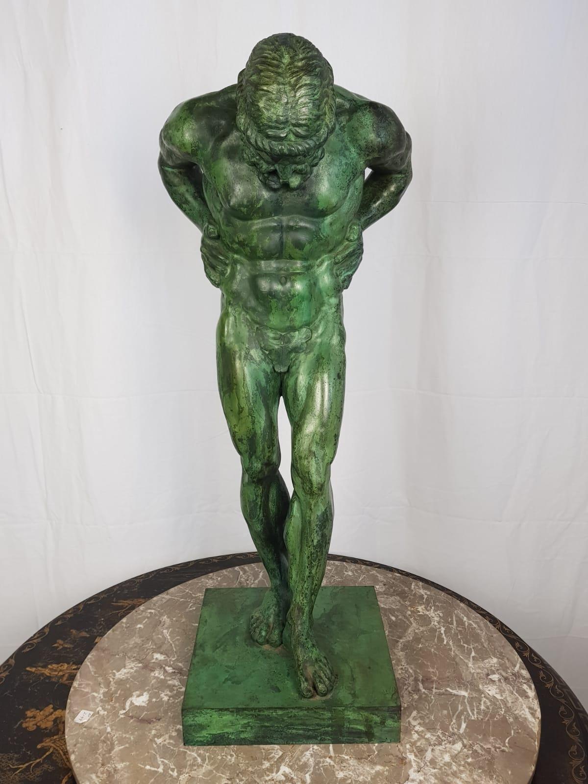 Atlas bronze of excellent casting and definition standing in and unusual pose with hands on his hips and normally with a globe on his shoulders in this depiction it is Atlas alone. A stunning green patina. Would create an atmosphere of strong