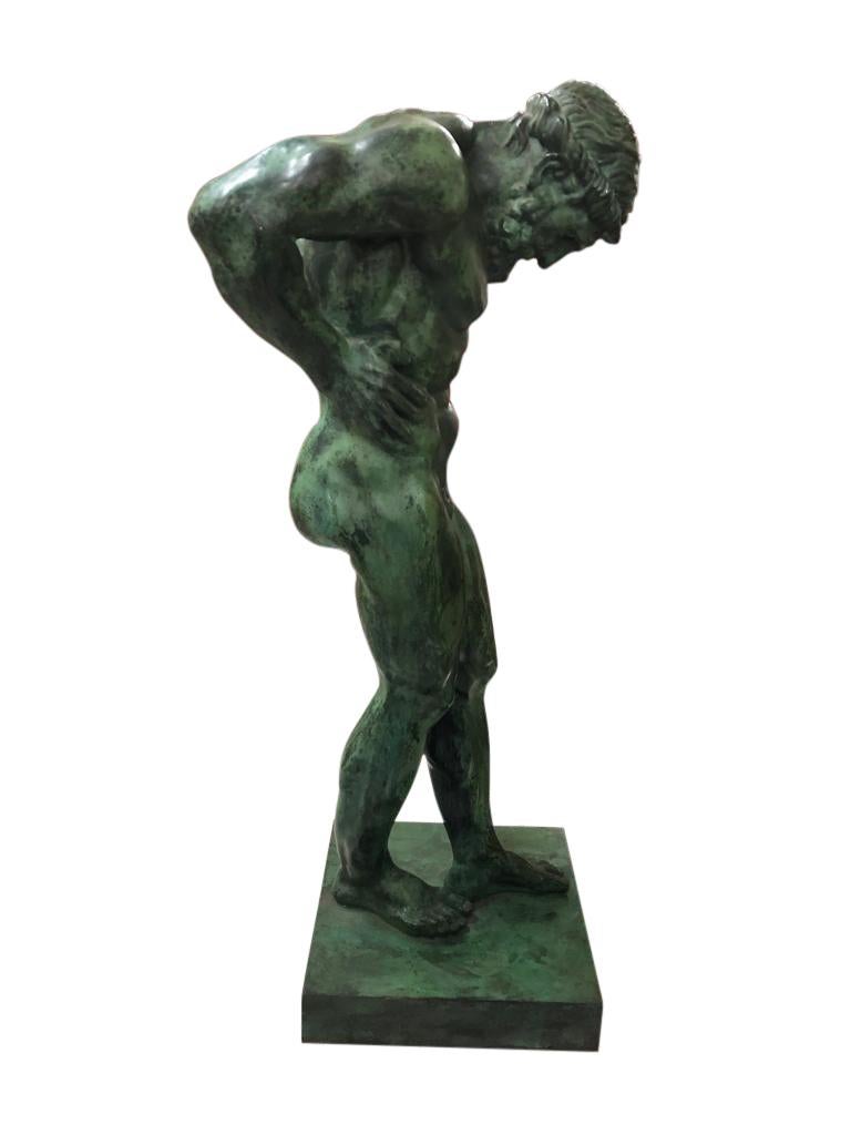 Atlas bronze of excellent casting and definition standing in and unusual pose with hands on his hips and normally with a globe on his shoulders in this depiction it is Atlas alone. A stunning green patina. Would create an atmosphere of strong