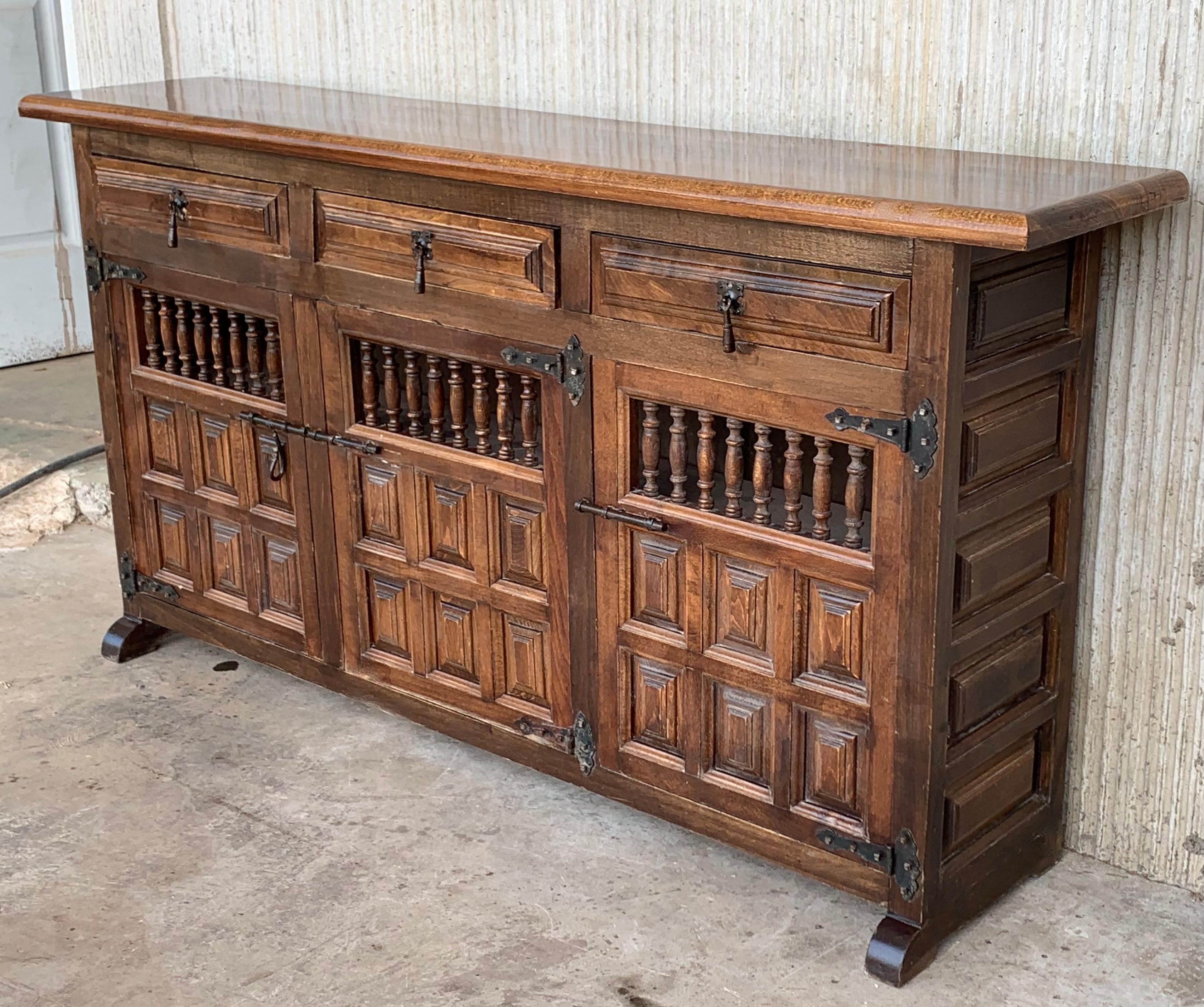 From Northern Spain, constructed of solid oak, the rectangular top with molded edge atop a conforming case housing three drawers over three doors, the doors paneled with solid walnut, raised on a plinth base.
Very heavy and original cabinet.
 