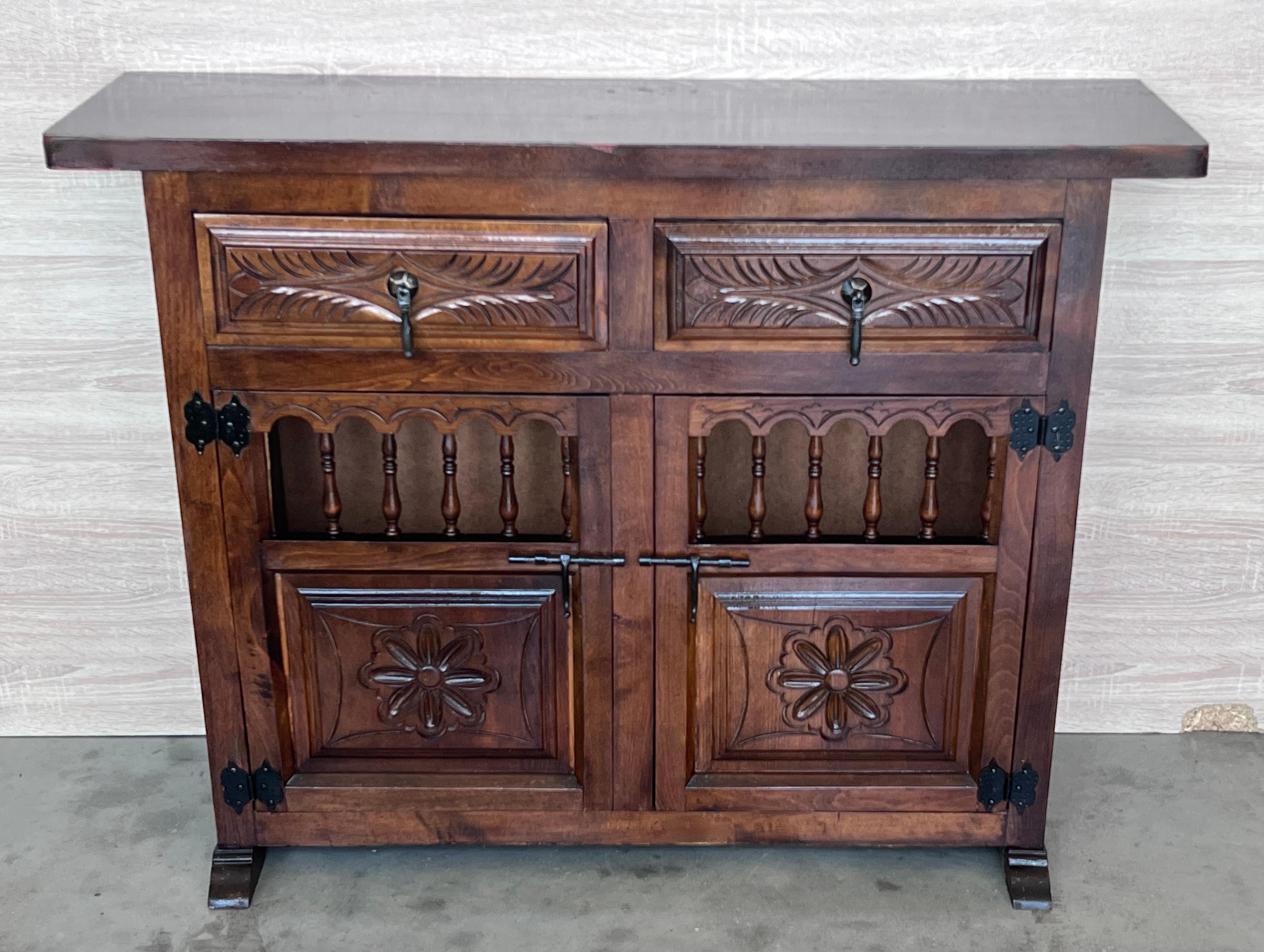 From Northern Spain, constructed of solid oak, the rectangular top with molded edge atop a conforming case housing two carved drawers over two carved doors, the doors paneled with solid walnut, raised on a plinth base.
Very heavy and original