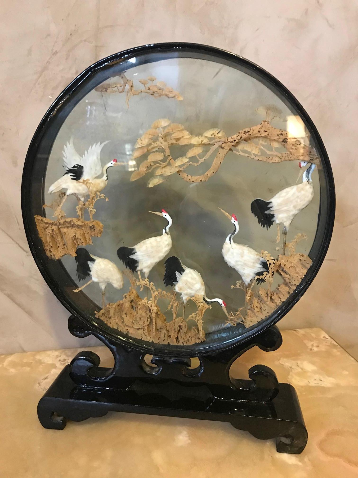 Chinese diorama made of vintage cork in glass and lacquered wood. Finely carved decoration in its glass case and brown lacquered base. Careful and delicate work of miniature sculpture, representing a Chinese landscape view, with many storks on