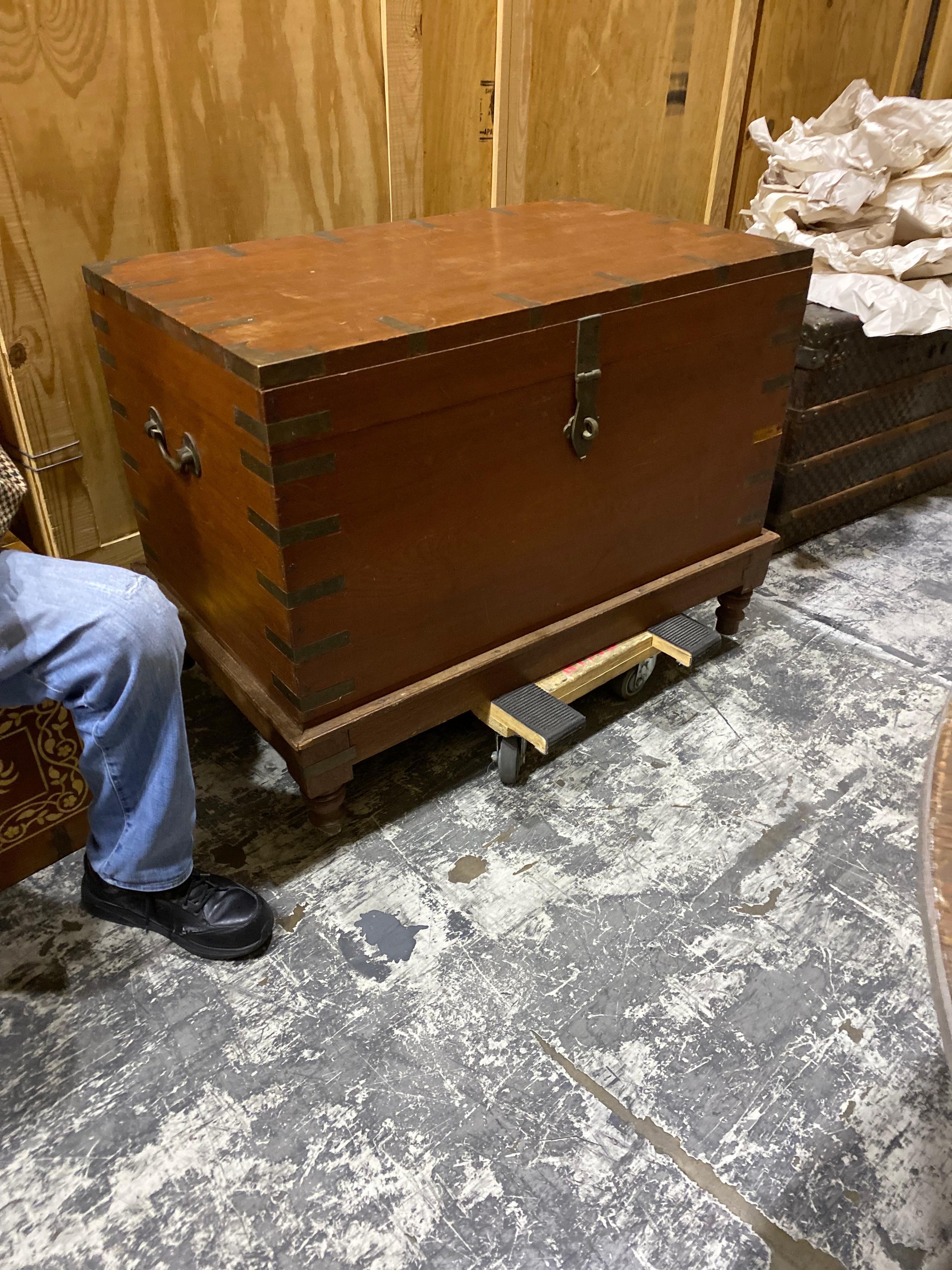 20th Century Large French Simple wooden trunk/ blanket chest
A simple wooden rectangular box construction with brass strap hardware on edges on a turned leg wooden stand. A candle box on top right corner. Possibly for storing sacred items like