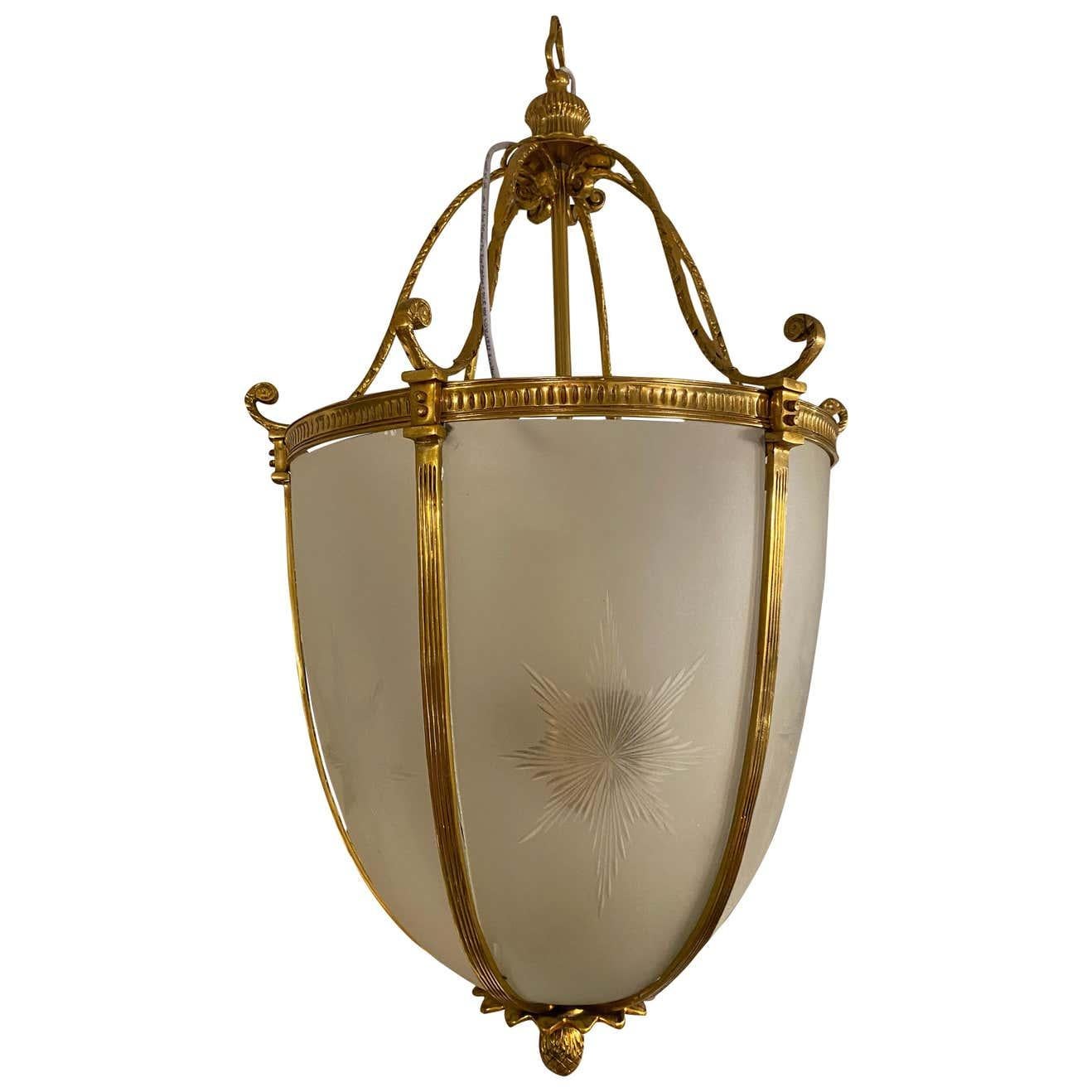 An impressive 20th century large hanging frosted glass and ormolu lantern. Each panel is etched with star burst and bowed panels. Excellent for home use.
