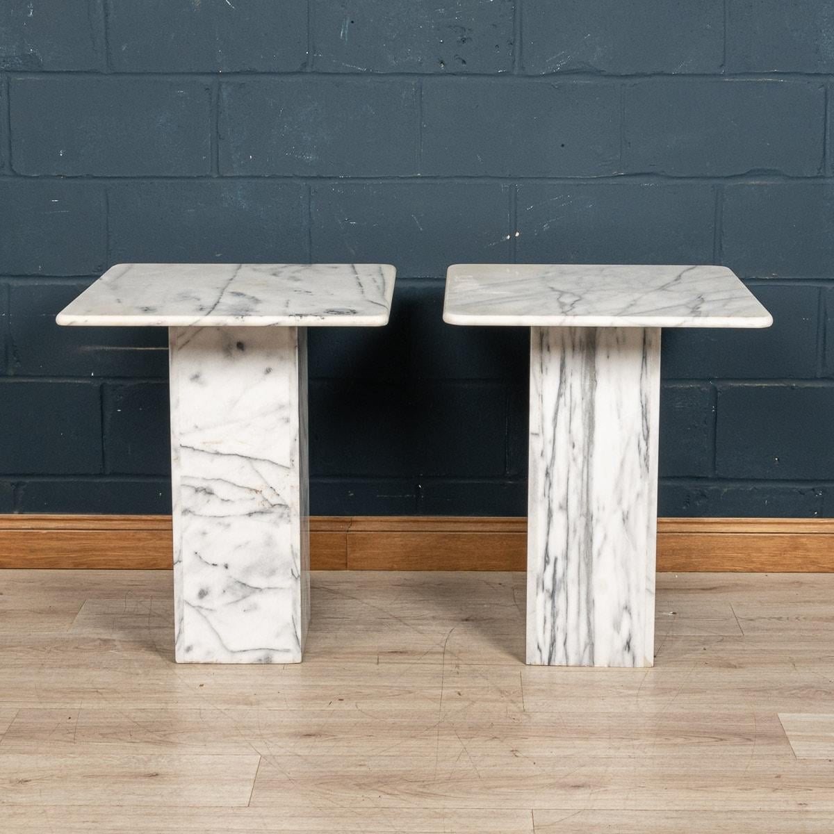 A lovely pair of tall marble side tables, made in Italy in the latter part of the 20th century. This impressive side table is composed by five individually polished slabs of Calacatta marble, conjoined to make a striking item of furniture. Together