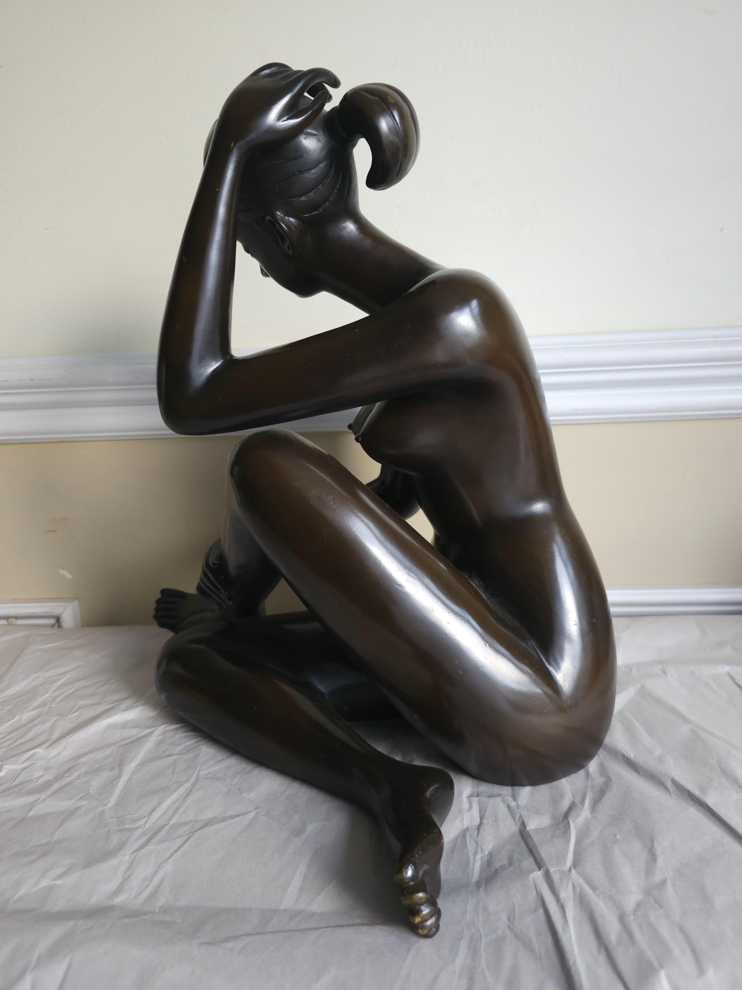 Bronze  Grande sculpture en bronze patiné du 20e siècle représentant une femme nue assise, signée en vente