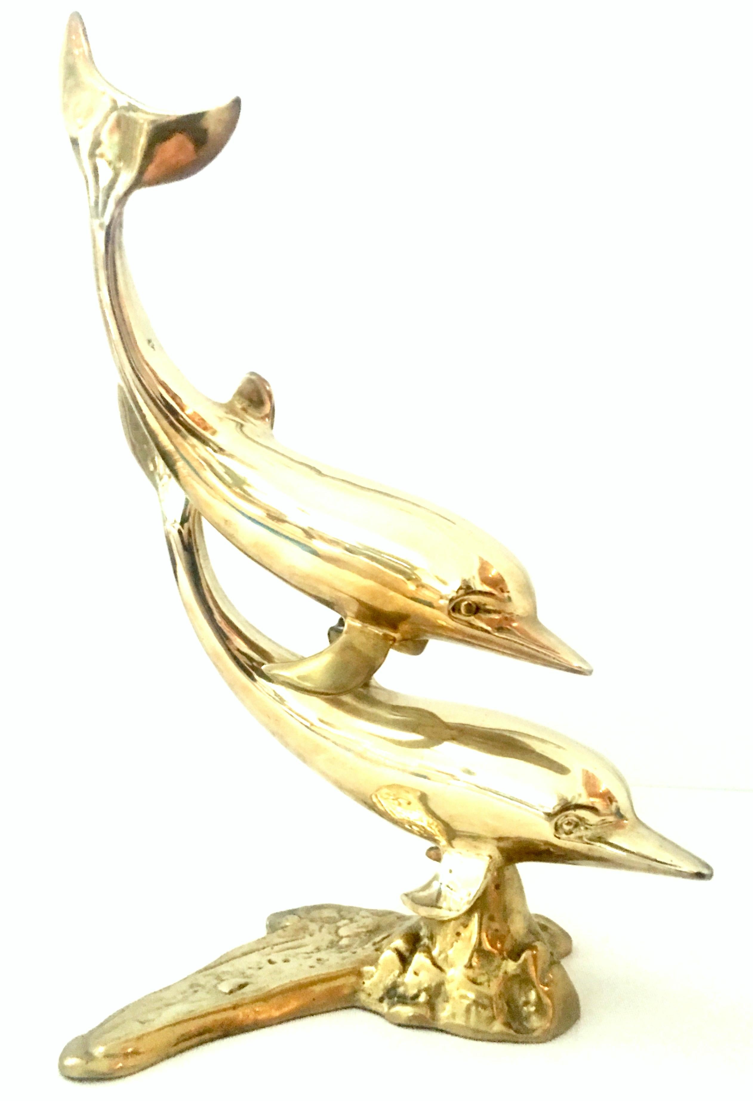 20th Century large scale polished solid brass double dolphin sculpture.