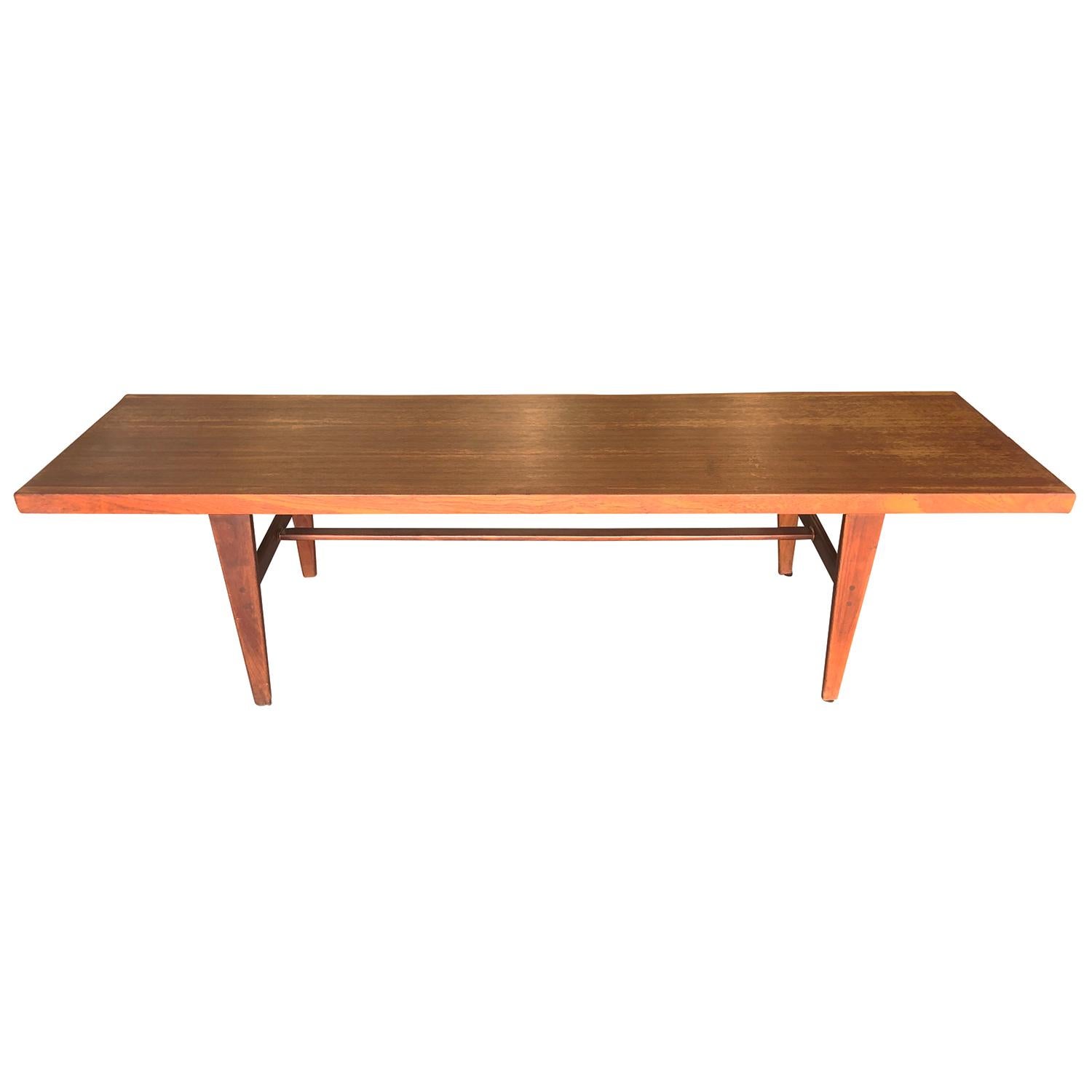 A vintage Mid-Century Modern Danish side, sofa table made of hand crafted Teakwood with extension, in good condition. The large Scandinavian coffee table is supported by four straight wooden feet. Wear consistent with age and use. Circa 1940 - 1960,