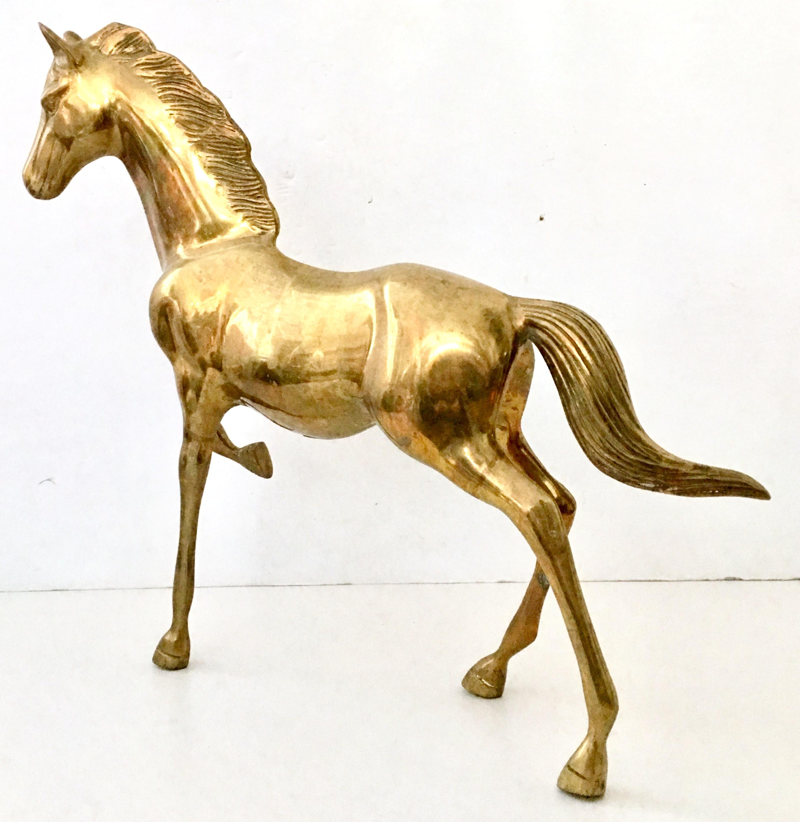 Mid-20th Century solid brass large galloping horse sculpture.