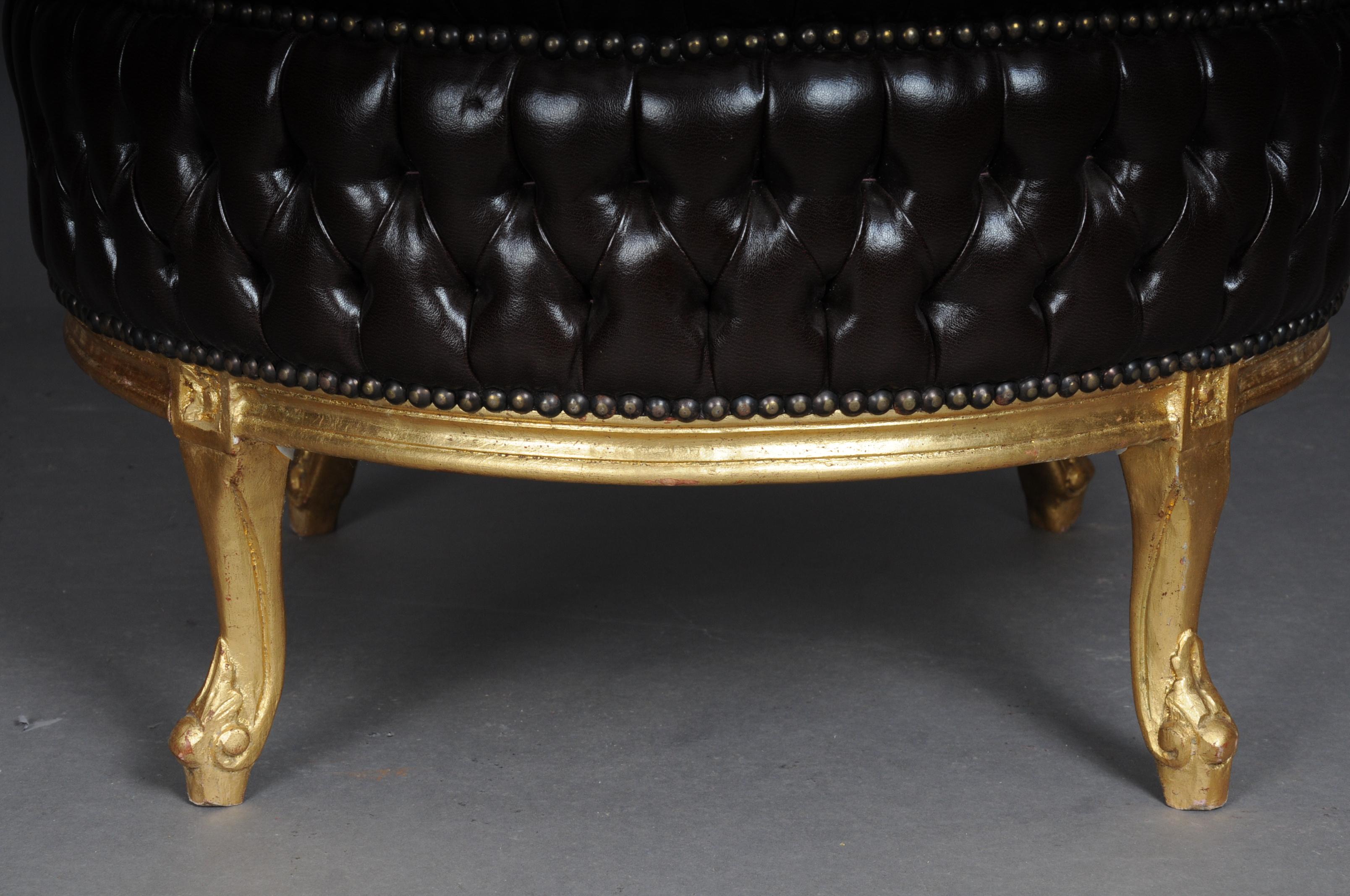 20th century large stool/bench, Chesterfield look

Unusual stool in the Classic English Chesterfield look. Seat cover made of brown sky leather.
Solid wood frame, gilded. 
France Louis XV style

(B-Mu-2).