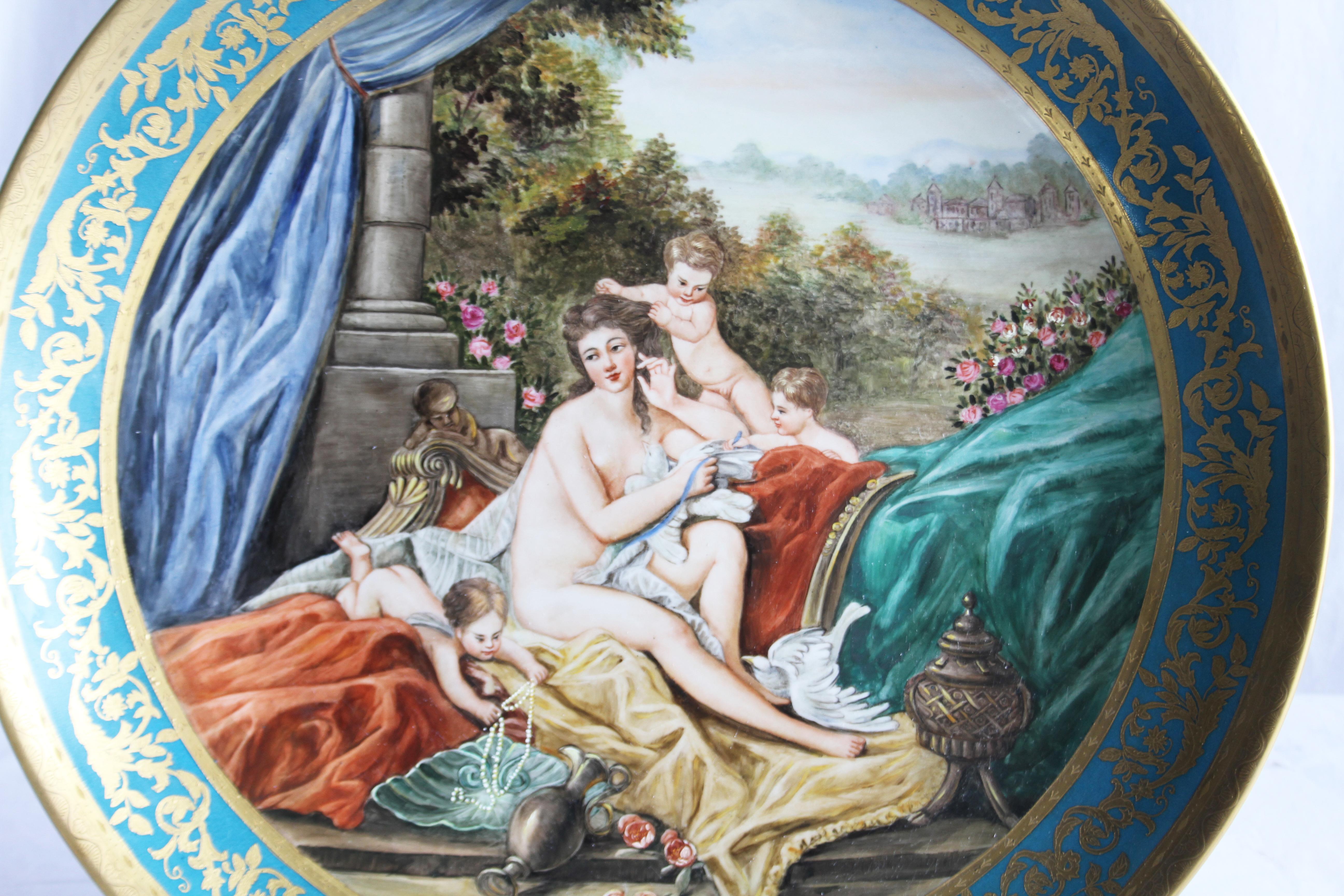 A large Vienna wall plaque, circa 1900. Decorated with a scantily clad classical maiden (Possibly Venus) and cherubs in a pastoral landscape. Gilt borders. Vienna mark on reverse.