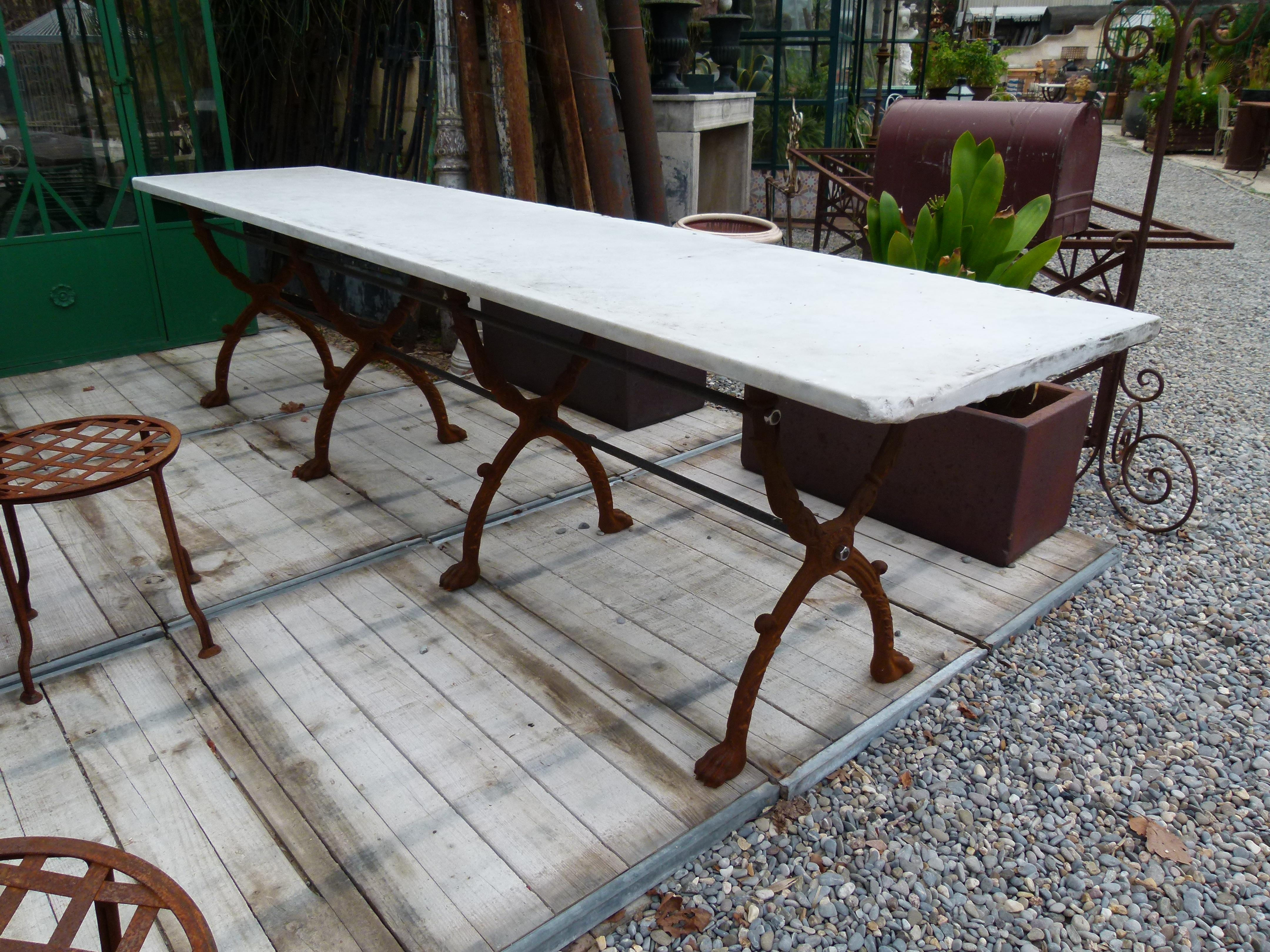 20th century large white Carrara marble garden table on a stable cast iron base.