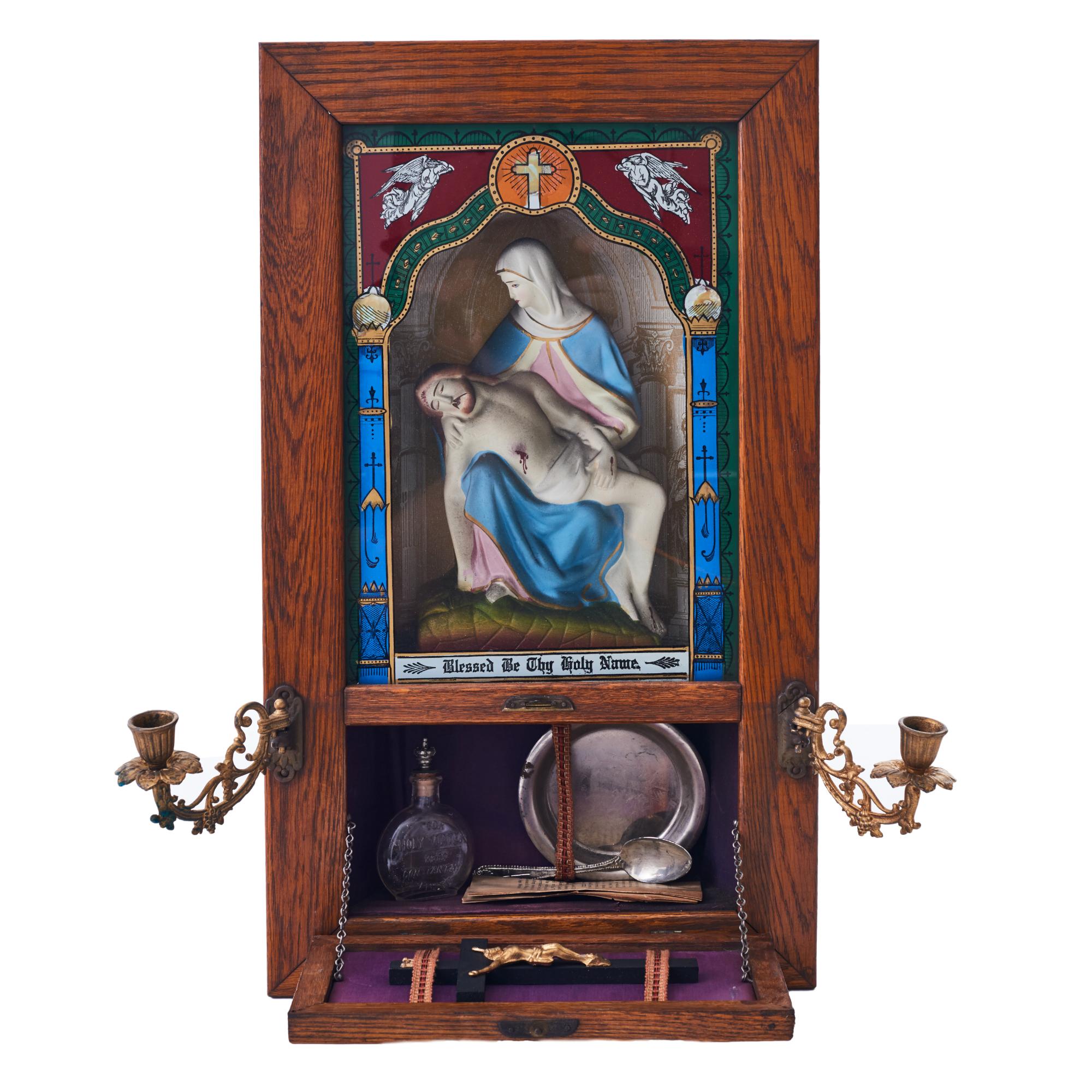 Beautiful mid-20th century antique oak Catholic Viaticum used for last rites, featuring the statue La Pieta under reverse painted glass and a picture of the Last Supper on the door of the compartment. Includes the original articulating candle