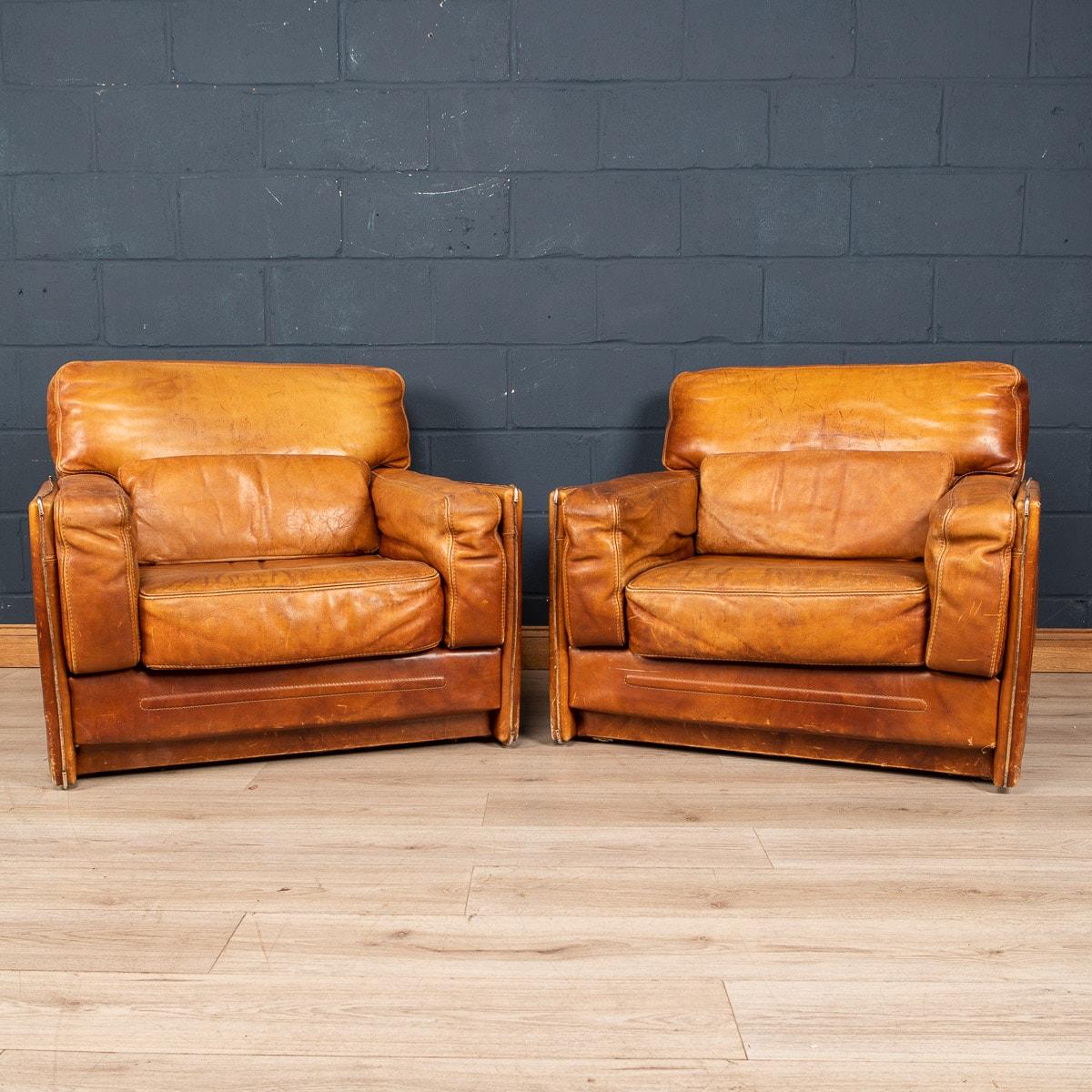 A beautiful pair of leather armchairs by Roche Bobois, made in France in the 1960s/1970s. The chairs are of wonderful quality, finished in the finest leather and majestic in size and extremely comfortable.

Condition
In Good Condition - wear