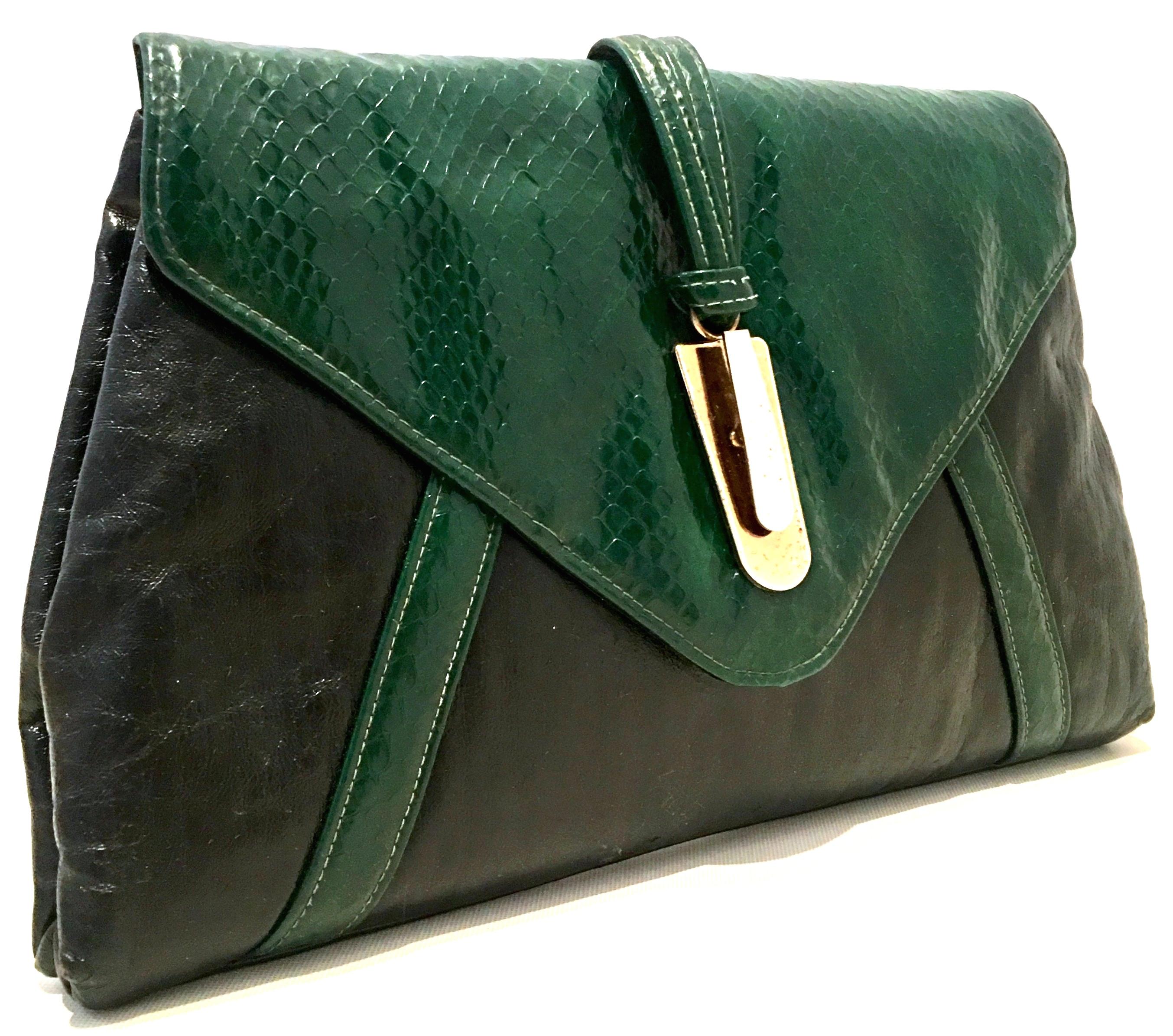 20th Century Leather & Python Clutch Hand Bag By, HL USA. This unique and coveted handbag features black leather with Kelley Green python, two tone front metal clasp hardware and gold stitch detail. The faux two tone chrome and gold exterior