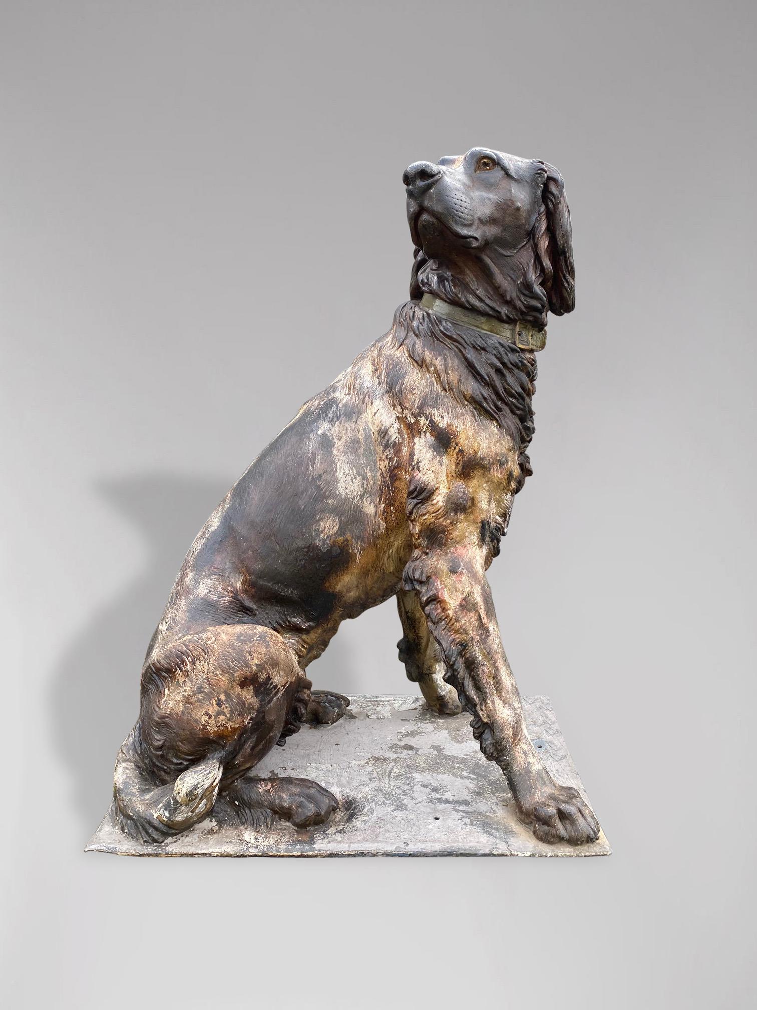 A stunning early 20th century life size cast iron statue of a Spaniel or Munster hunting dog. A very handsome statue, sitting on a plinth base, fully three dimensional and looks good from all sides. German. Exceptional quality and superb