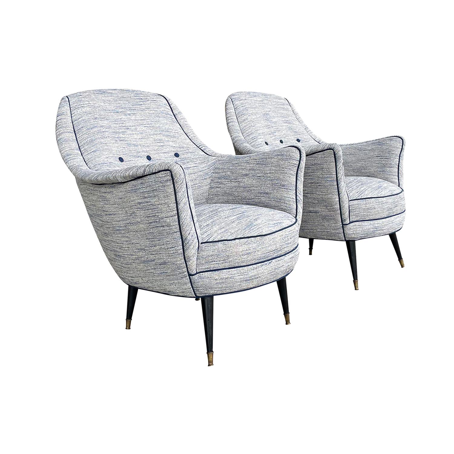 A light-blue, vintage Mid-Century Modern Italian pair of lounge chairs with a button-tufted back, designed most likely by Ico Parisi in good condition. The seat backrest of the armchairs, club chairs are slightly leaned to the back with outstretched