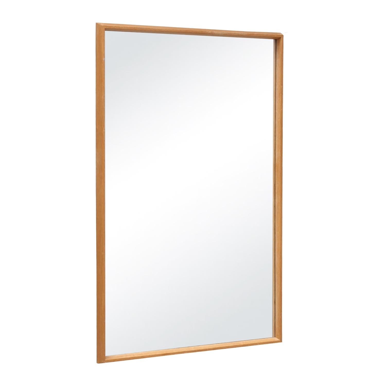 A rectangular, vintage Mid-Century Modern Danish wall mirror with its original mirrored glass, made of hand crafted Oakwood in good condition. Wear consistent with age and use, circa 1950 - 1970, Denmark, Scandinavia.