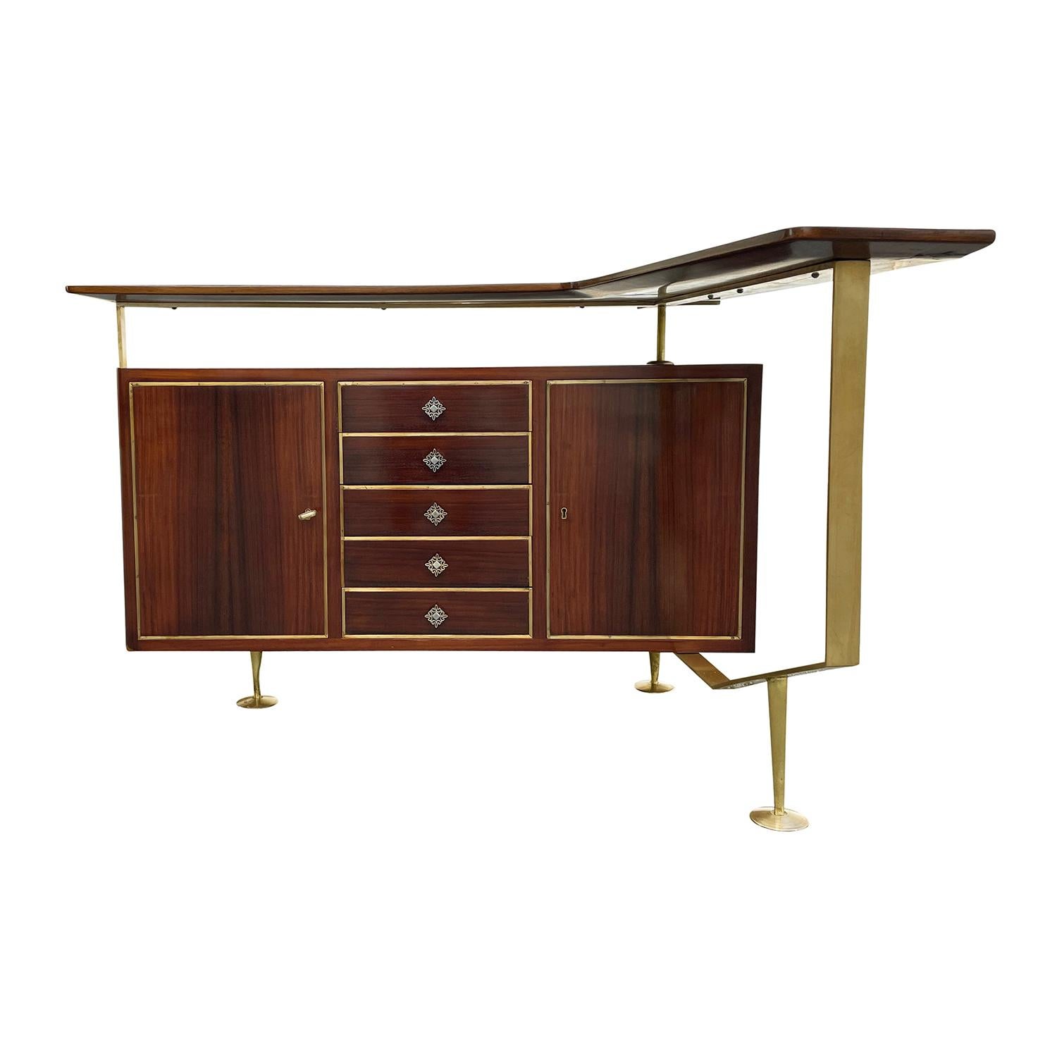 A light-brown, vintage Mid-Century Modern Italian narrow cocktail bar with an elevated L-form top, made of hand crafted polished, partly veneered Walnut in good condition. The freestanding cabinet is composed with two doors and five drawers,