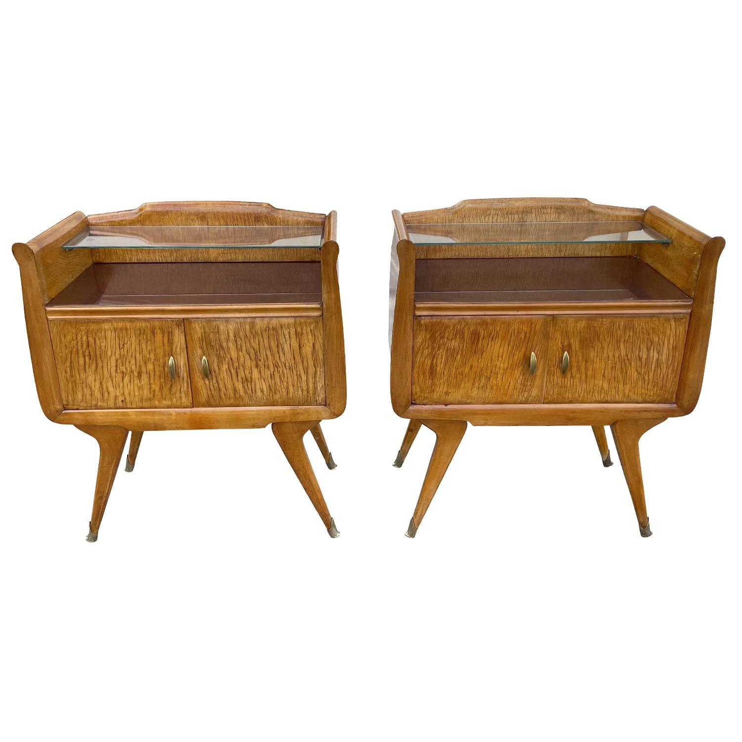 A vintage Mid-Century modern Italian pair of nightstands made of hand crafted polished Maplewood, designed by Paolo Buffa in good condition. The bed side tables are composed with a glass shelf and two small doors, detailed with its original brass