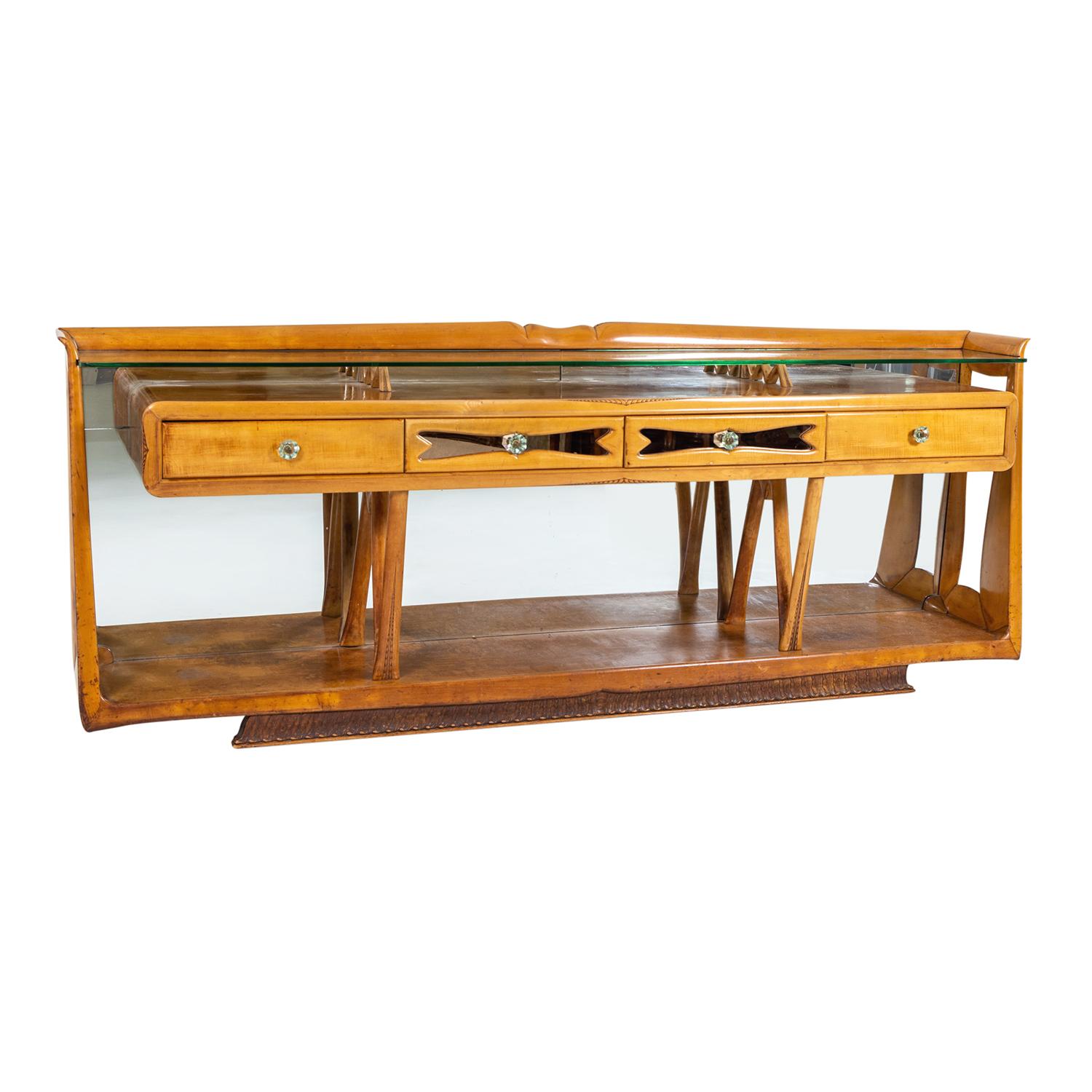 A light-brown, vintage Mid-Cenutry Modern Italian sideboard with a clear glass top made of hand crafted polished maplewood and walnut, in good condition. The large credenza is composed with four drawers which are supported by four arched legs, the