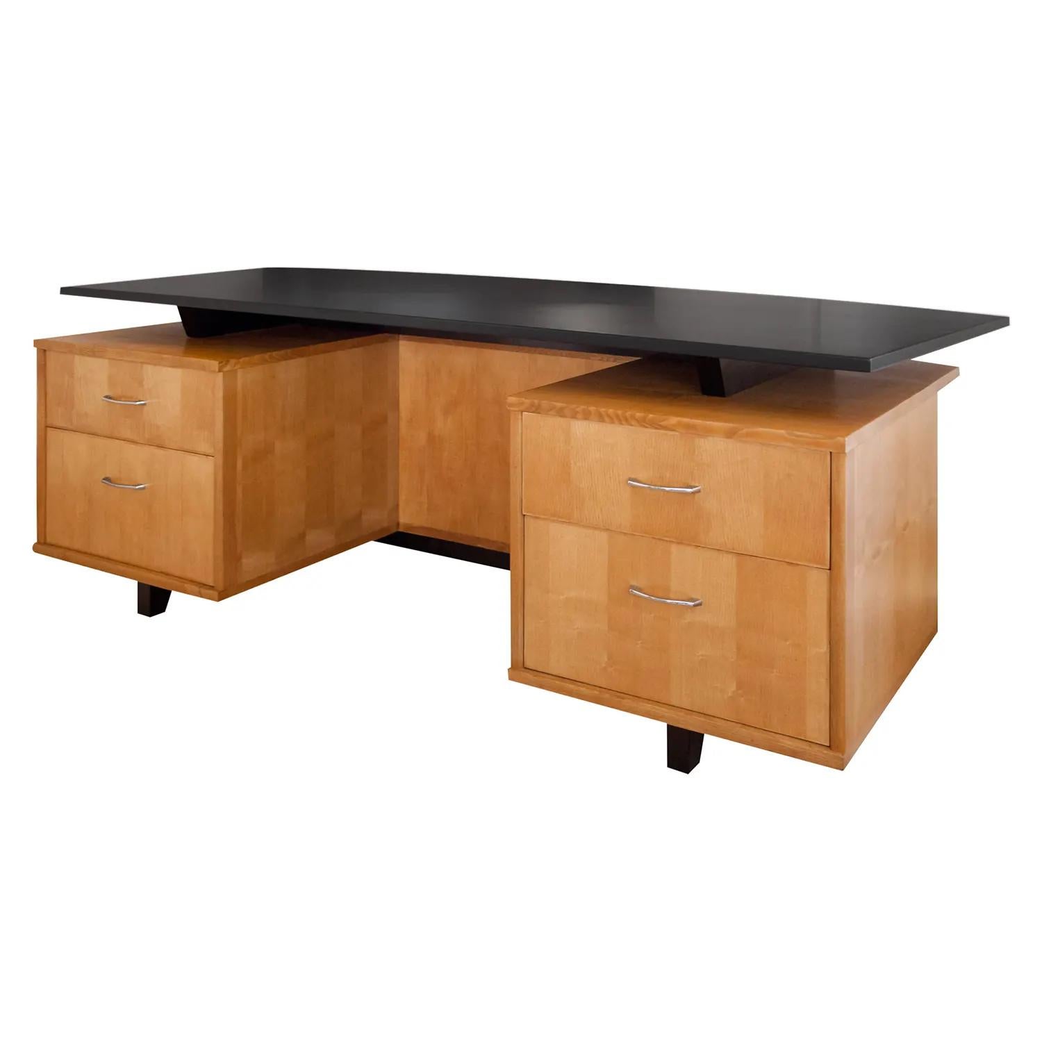 A freestanding, vintage Mid-Century modern Italian writing table made of hand crafted polished, partly veneered Maplewood with a large black Ebony table top, in good condition. Each side the desk is composed with one large and one small drawer,