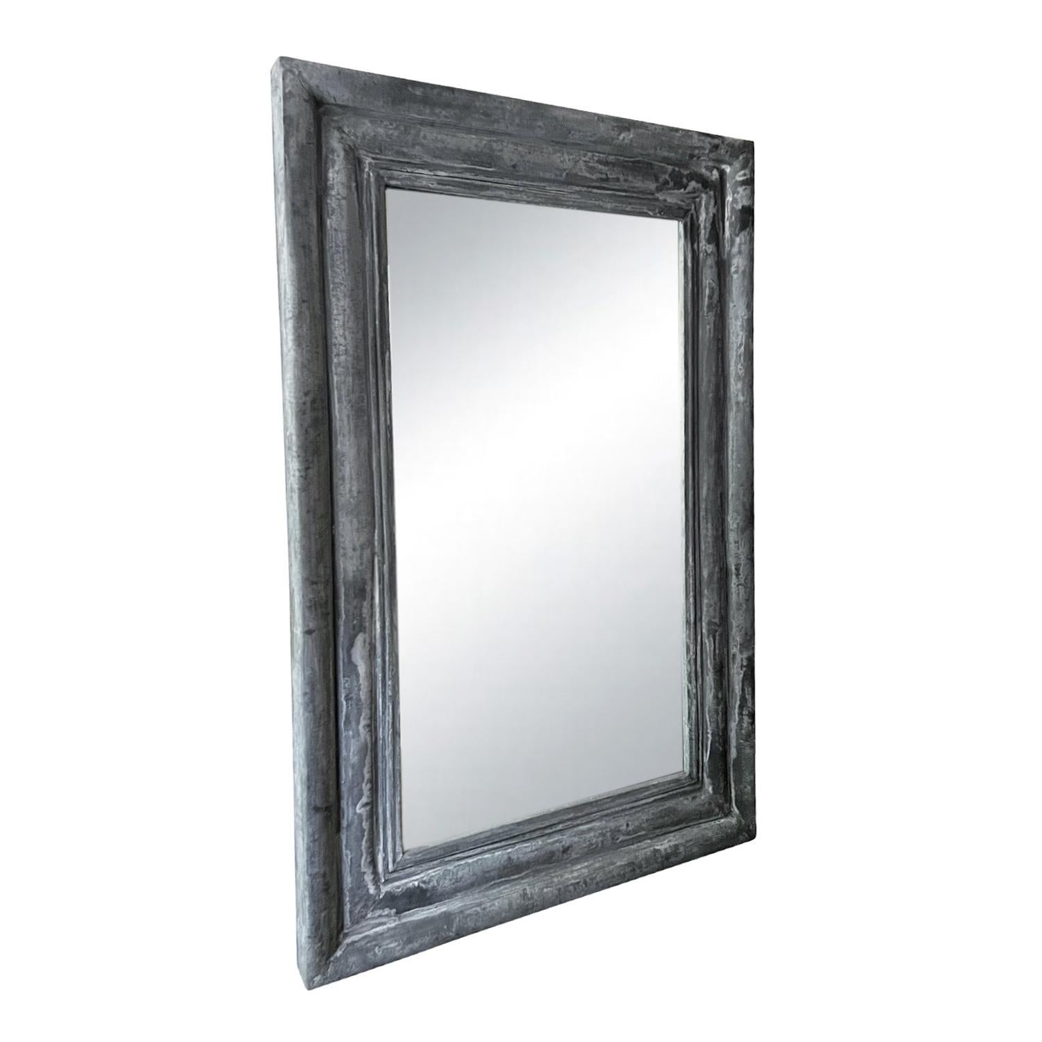 Oversized mirror with a heavy antique zinc bevelled frame. Wear consistent with age and use. Circa 1930, France.