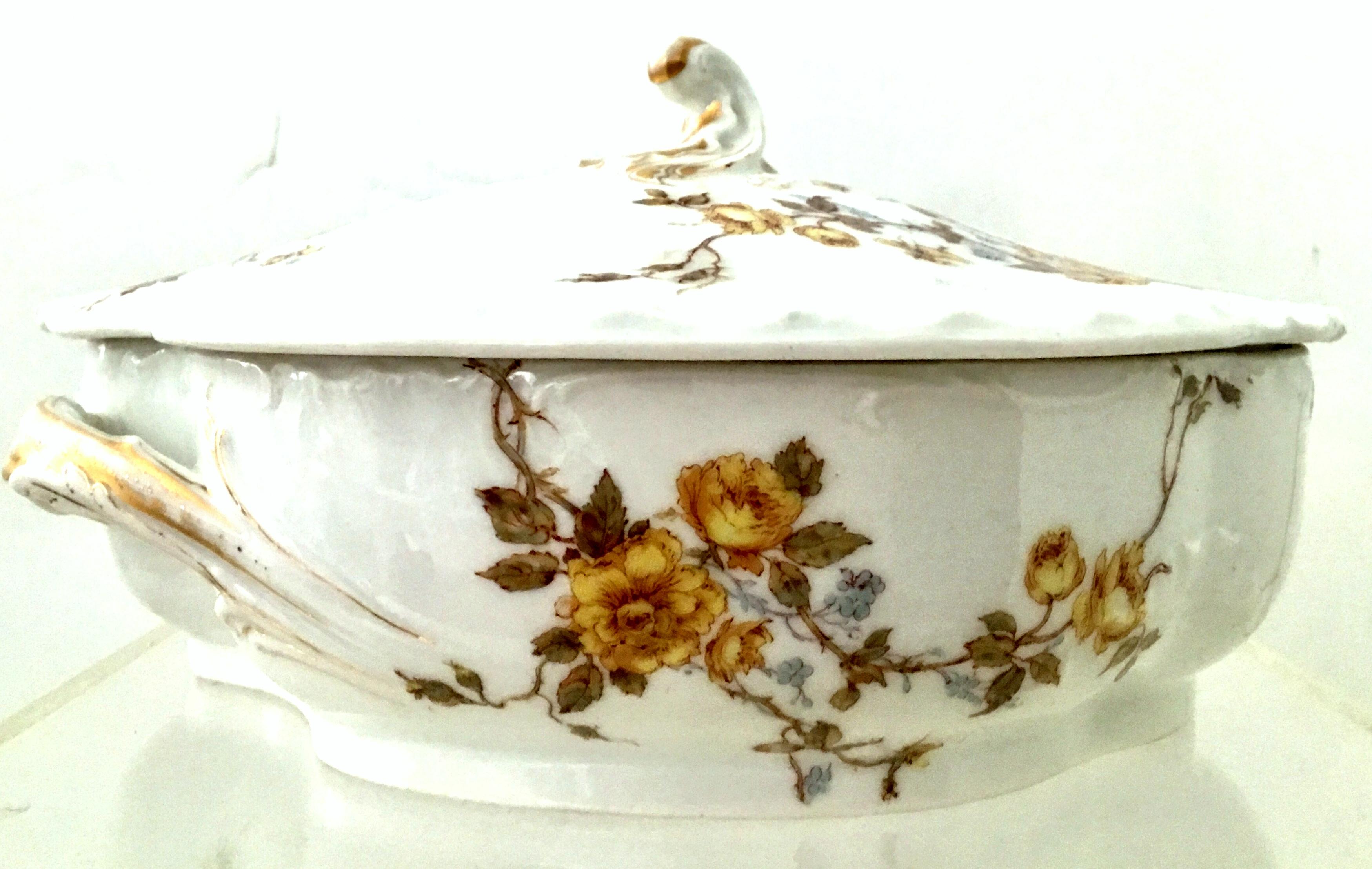 Early 20th century Limoges France lidded serving dish by Haviland & Co. This oval and oblong
lidded serving dish features a bright white ground with 22-karat gold detail and a scattered yellow with French blue rose pattern. Both the bottom and top