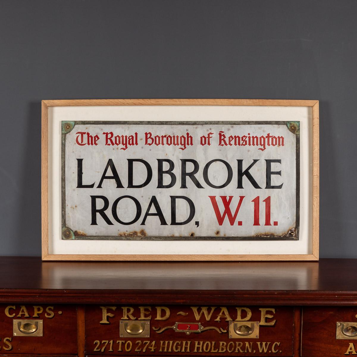 Antique early-20th century Ladbroke Rd W11 street sign, enamel on metal, Royal Borough of Kensington, from the 1900's. Comes in a newly made frame, a truly wonderful conversation piece capable of transporting the imagination to a bygone