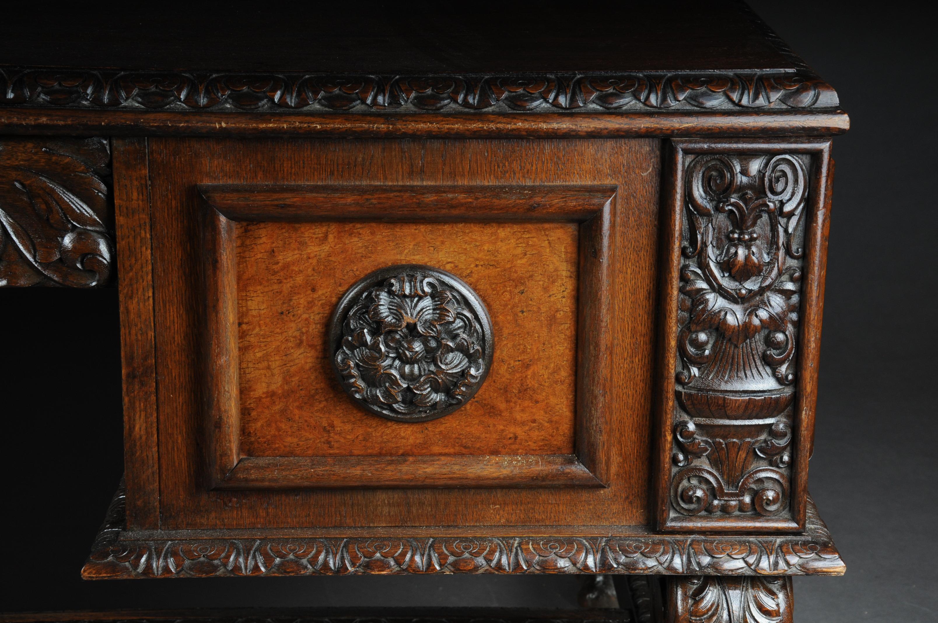 lordly Neo Renaisansce desk solid oak

Masterful oak desk. Massive oak carved and partly walnut veneer. Slightly protruding cover plate. Desk that stands on paw-shaped feet which is connected to a central bridge. Extremely rich and finely