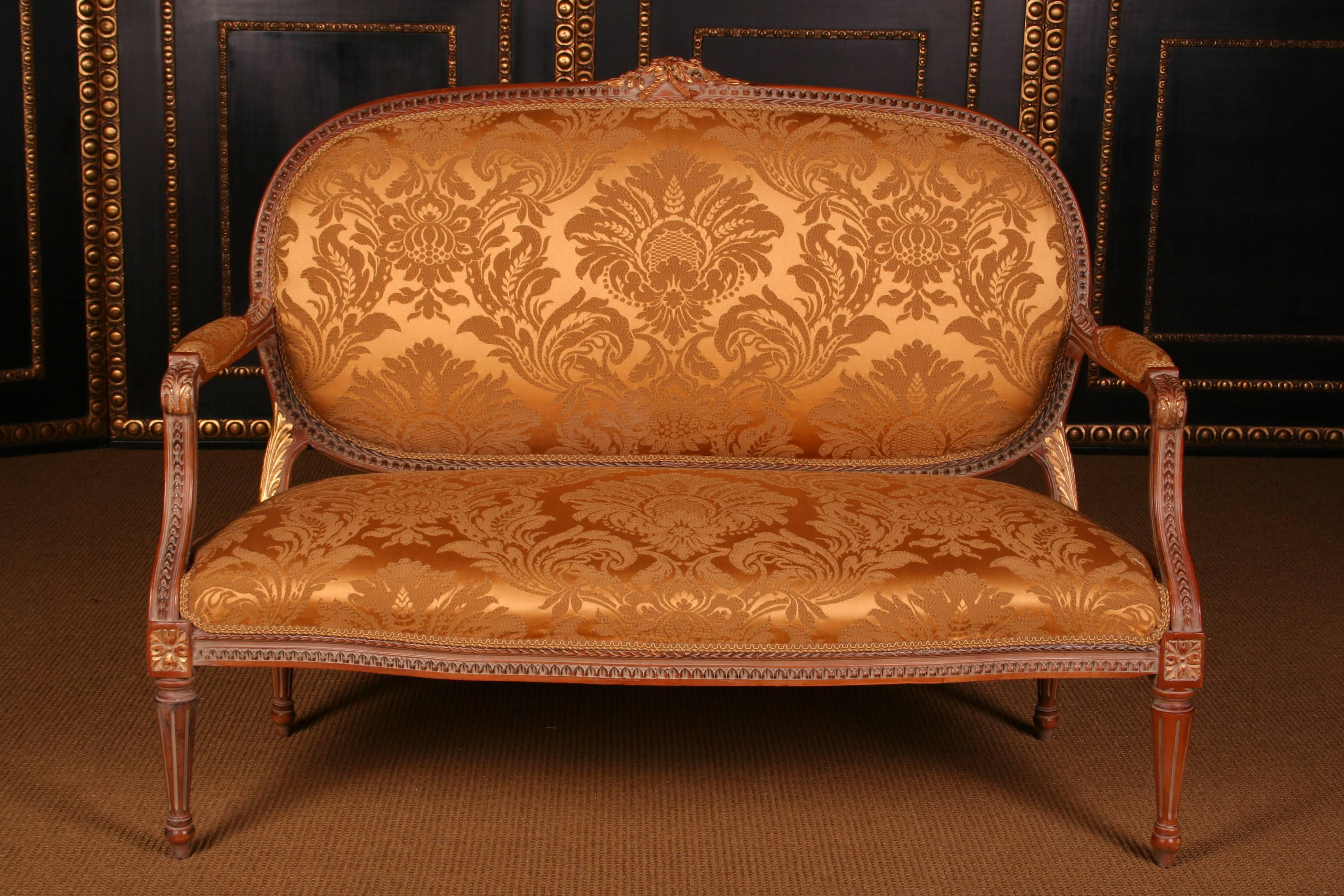 Unique French garniture in Louis 16th style
Solid beechwood, finely carved and patinated.  

Measurements:
Sofa: Width 135 cm, height 100 cm, depth 70 cm
Armchair: Width 67 cm, height 97 cm, depth 60 cm

(B-Dom-64).