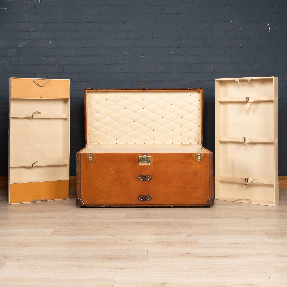 A very rare wardrobe trunk by Louis Vuitton dating to the early part of the 20th century, (circa 1900/1910). Covered in the famous orange “Vuittonite“ canvas, this horizontal courier trunk is much rarer than its monogrammed brothers with its stain