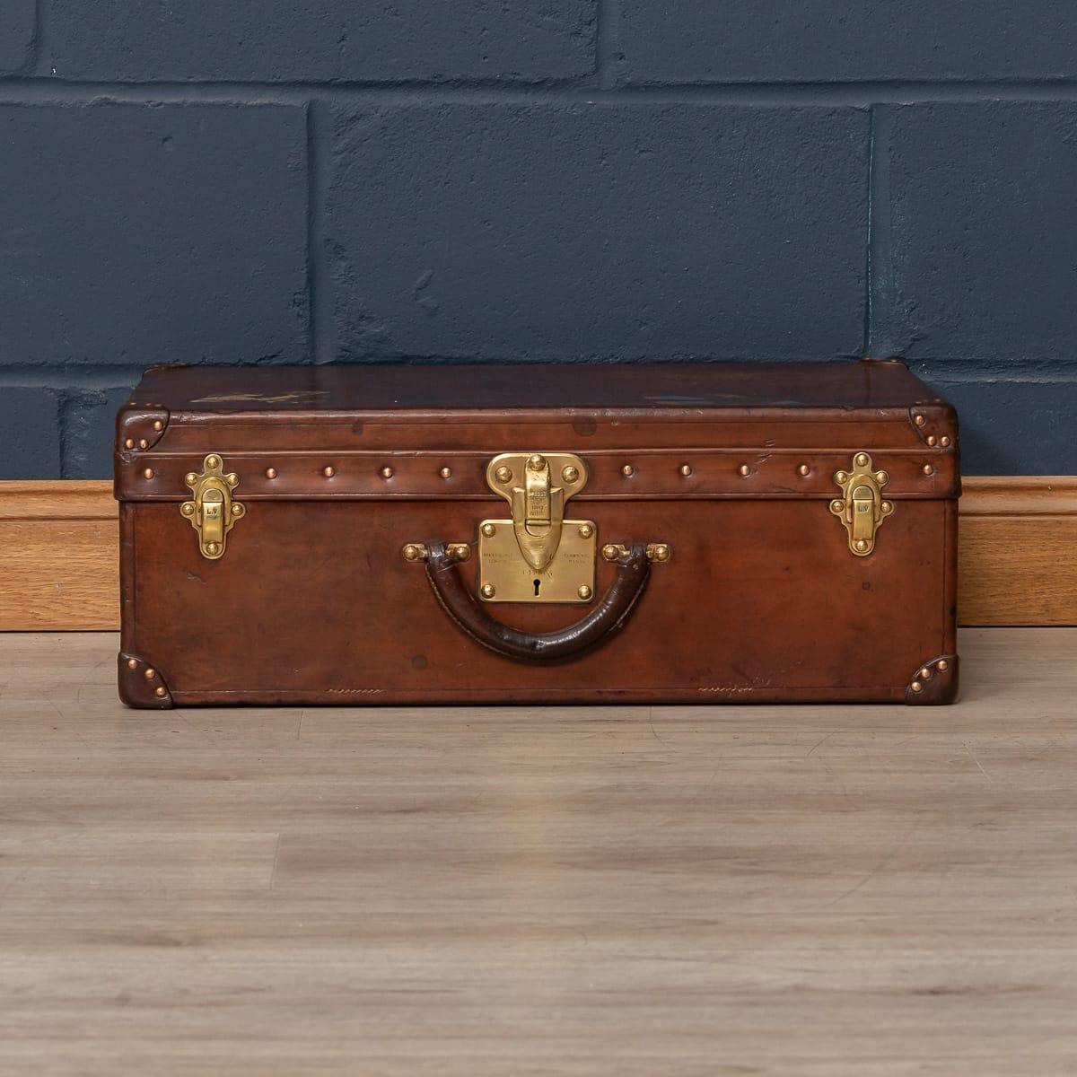 A very rare Louis Vuitton suitcase dating from the early part of the 20th century, covered not in the world famous (but more common) monogram canvas but in a single piece of cow hide. These all-leather trunks and cases were made by special order and