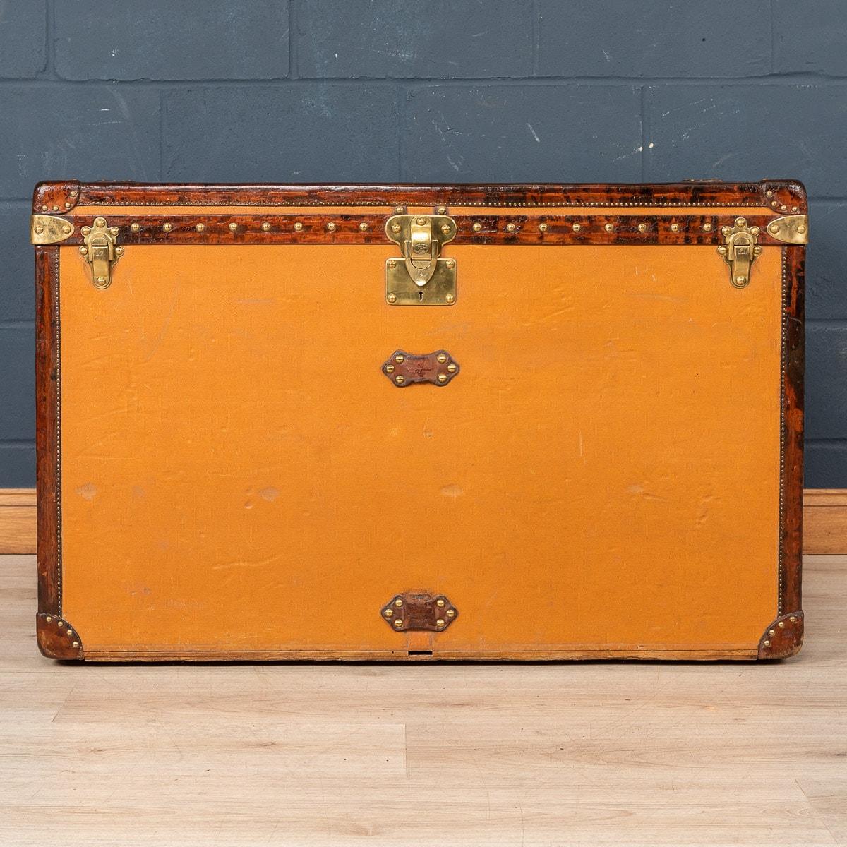 A very rare Louis Vuitton “high trunk” trunk (from French “Malle Haute”), circa 1900's, features orange “Vuittonite“ canvas, all brass hardware, and leather trims. It is rare to find these trunks in as good condition as this one. Trunks in this type