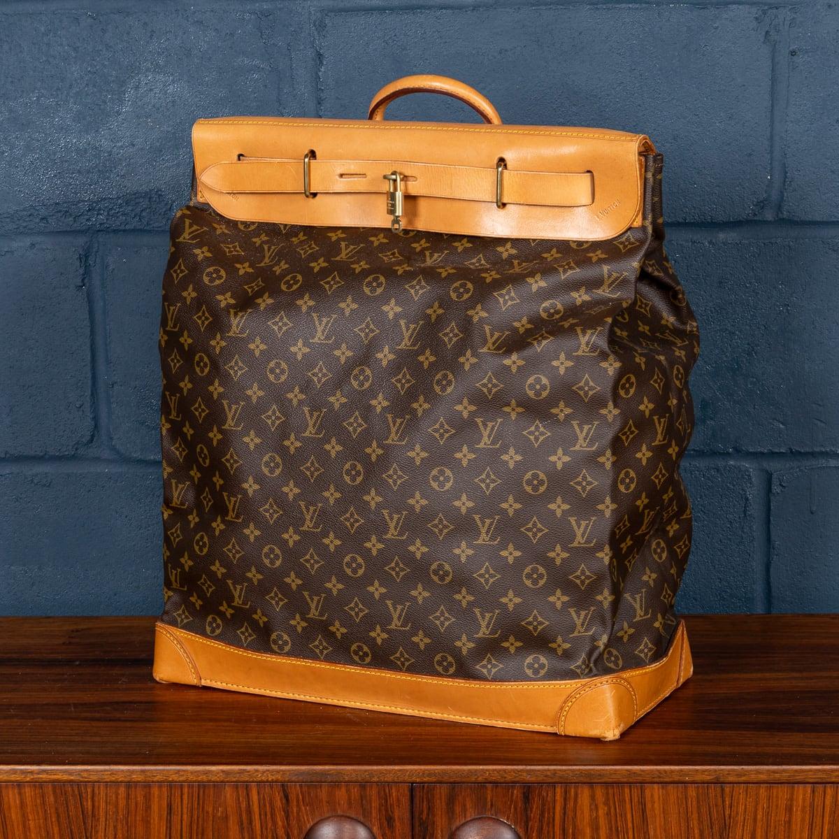 A Louis Vuitton steamer travel bag covered monogram canvas and natural tan leather, serves as a quintessential representation of the brand's unwavering commitment to a design that harmonises style and utility. Inspired by the practical proportions