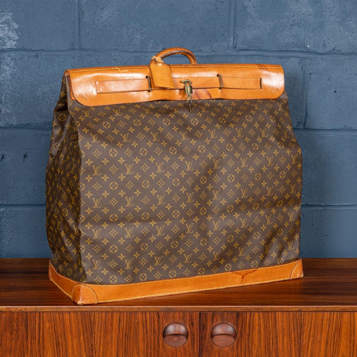 A Louis Vuitton steamer travel bag covered monogram canvas and natural tan leather, serves as a quintessential representation of the brand's unwavering commitment to a design that harmonises style and utility. Inspired by the practical proportions