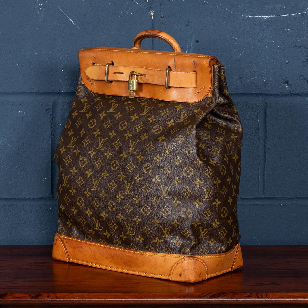 A lovely Louis Vuitton steamer travel bag in monogram canvas and natural tan leather, made in France in the latter quarter of the 20th century. Steamer bags have been produced by Louis Vuitton for over 120 years. In 1901, the company introduced the
