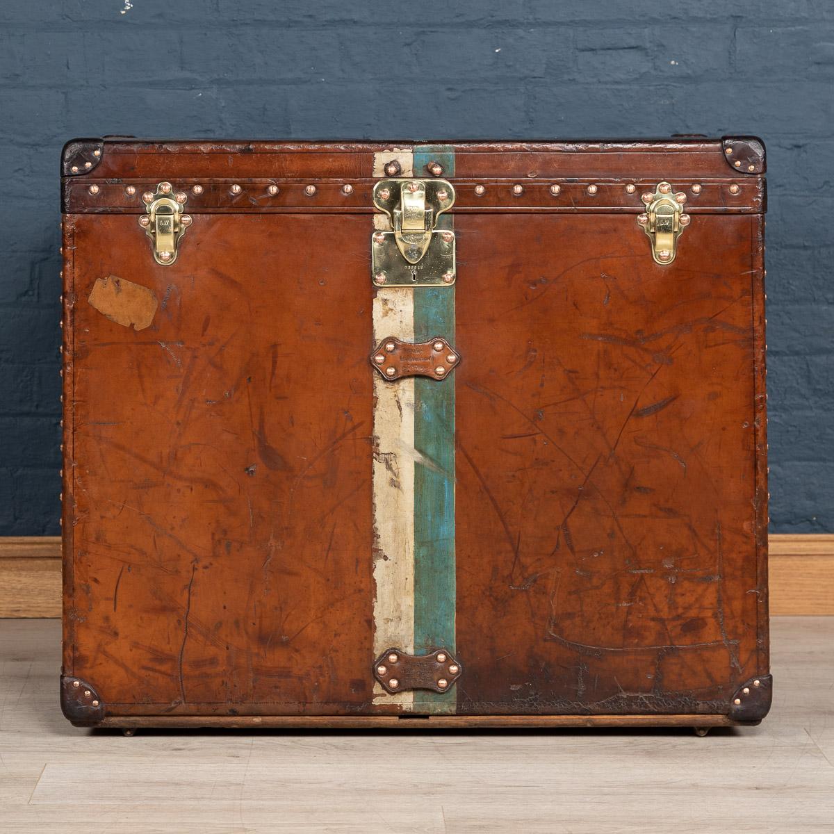 A very rare Louis Vuitton “malle haute” or “high trunk“. Dating to the early part of the 20th century, covered not in the world famous (but more common) monogram canvas but in a single piece of cow hide. These all-leather trunks were made by special
