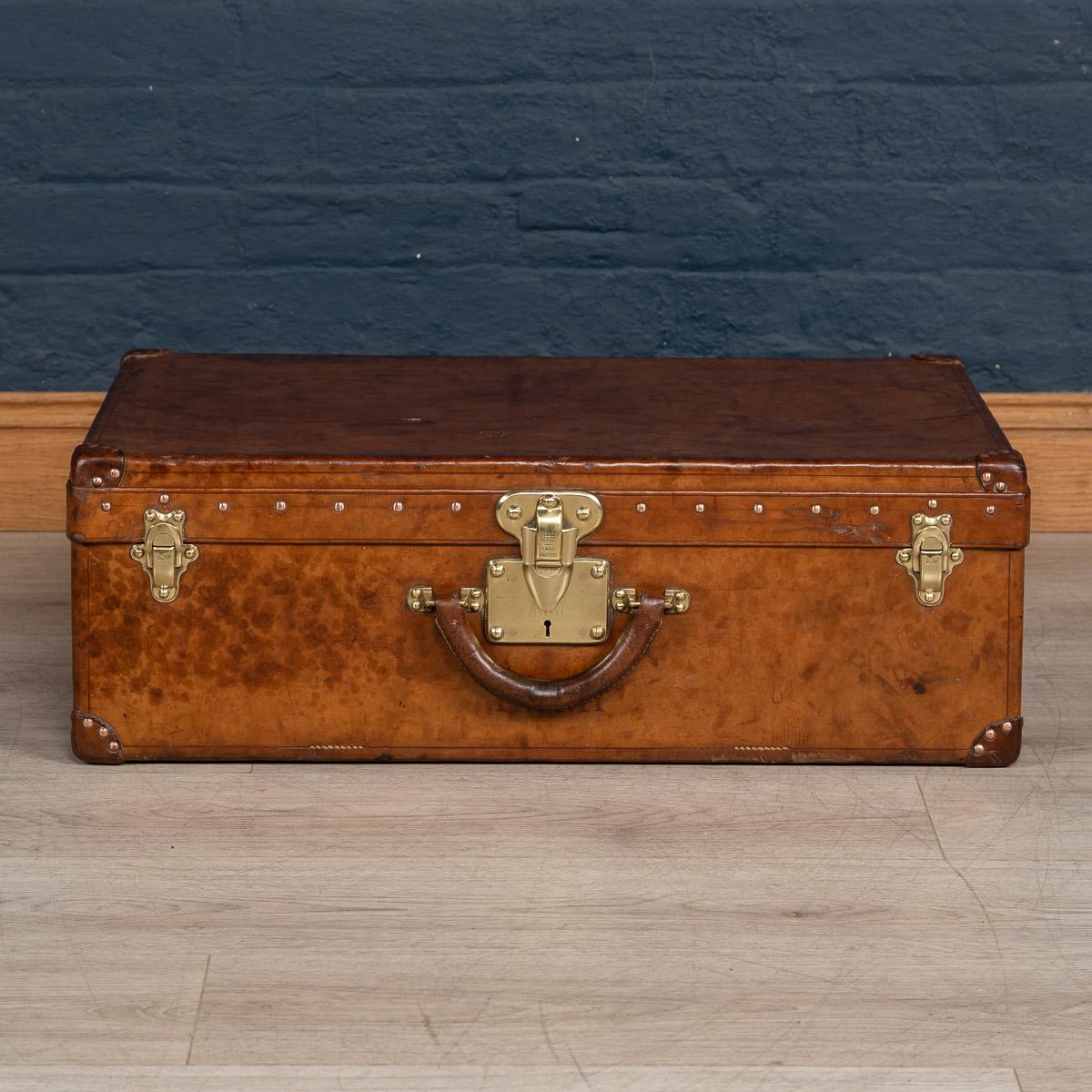 Antique 20th century very rare Louis Vuitton suitcase, covered not in the world famous (but more common) monogram canvas but in a single piece of cow hide. These all-leather trunks and cases were made by special order and Louis Vuitton used to take